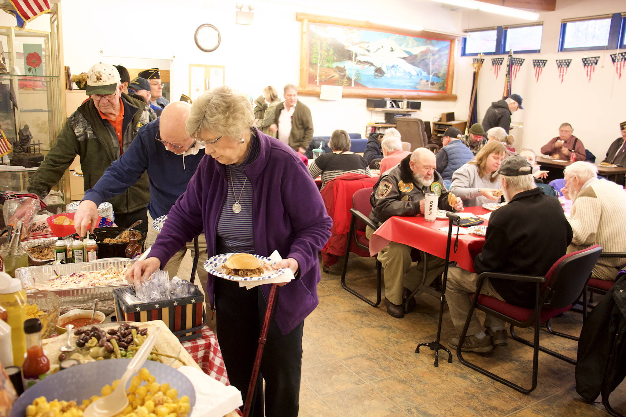 Military veterans, family members and others gather at American Legion Auke Bay Post 25 at midday Saturday for an annual Veterans Day lunchtime gathering. (Mark Sabbatini / Juneau Empire)