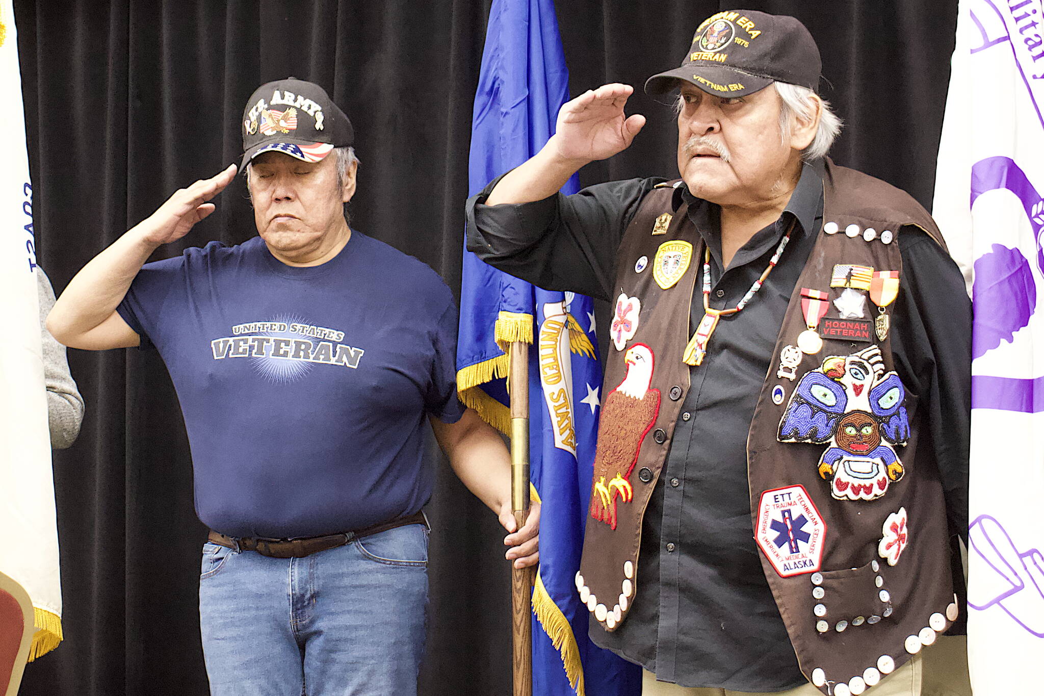 John Phillips (left) and Roger Sheakley salute the colors during the opening of the Southeast Alaska Native Veterans’ observance of Veterans Day on Saturday at Elizabeth Peratrovich Hall. (Mark Sabbatini / Juneau Empire)