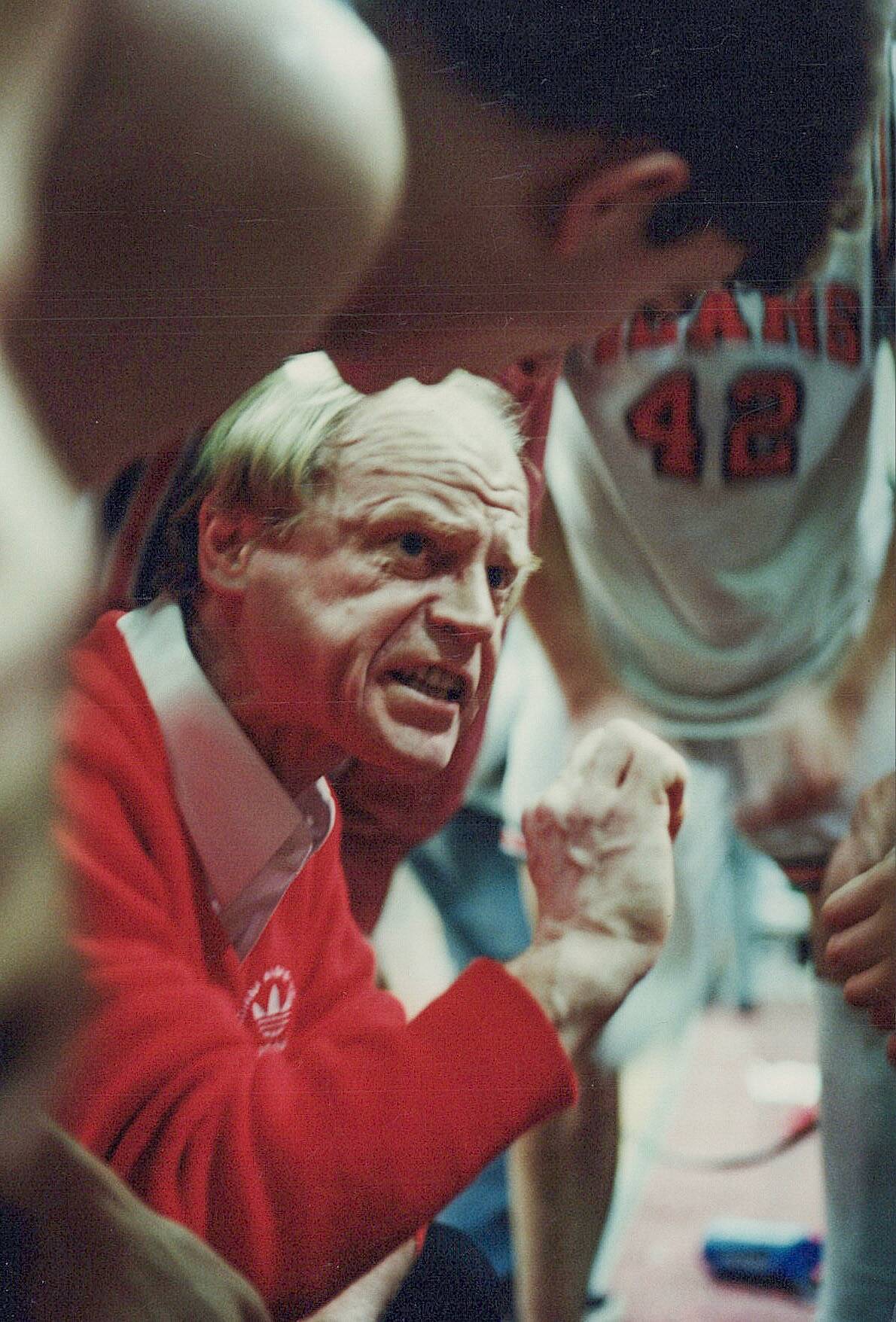 Juneau-Douglas High School coach George Houston is shown during a huddle during the Crimson Bears state tournament semi-final win over East Anchorage in 1997. (Brian Wallace / Juneau Empire File)