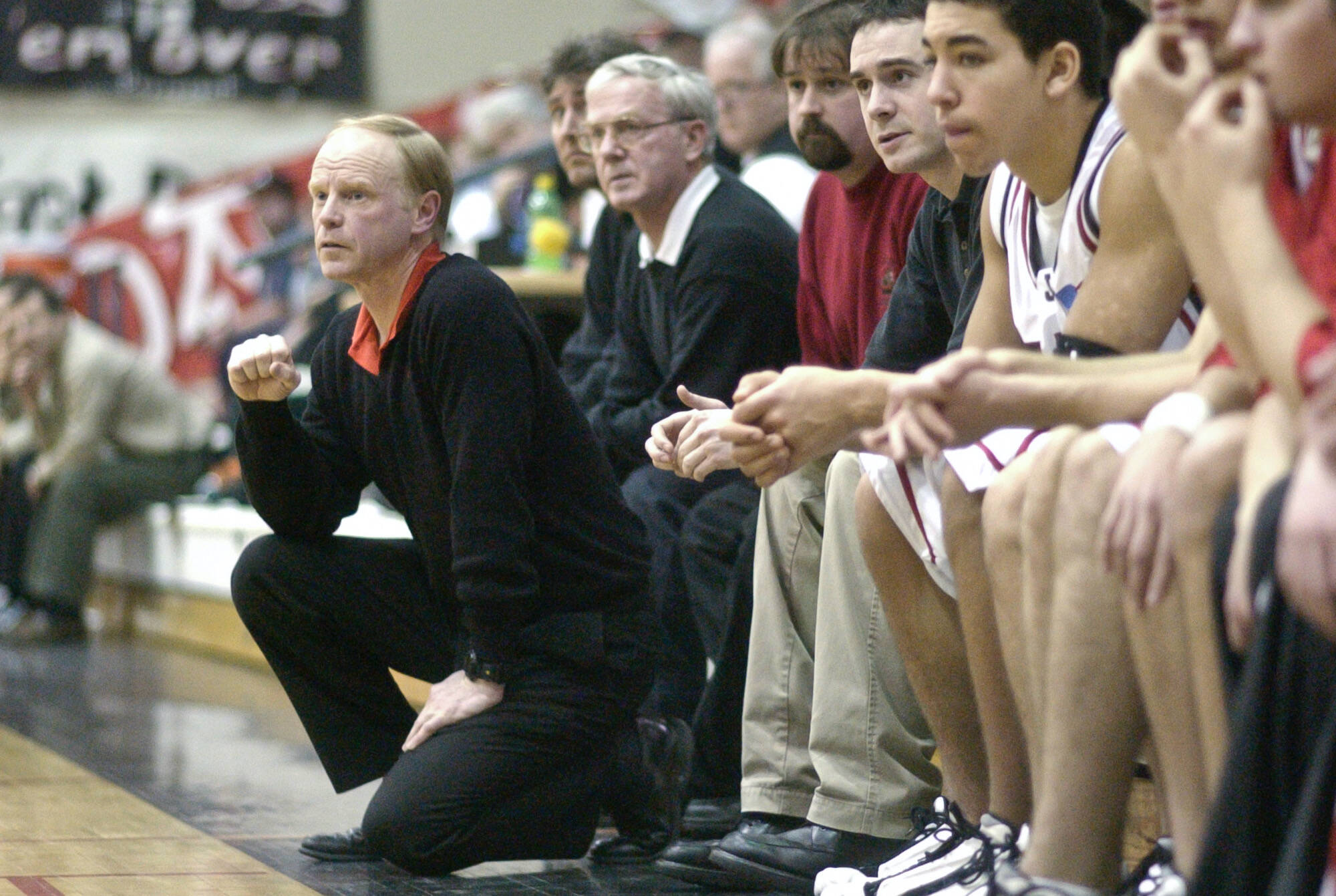 George Houston, head coach of what at the time was Juneau-Douglas High School, watches his team play Colony High School in February of 2002 at JDHS. (Michael Penn / Juneau Empire File)