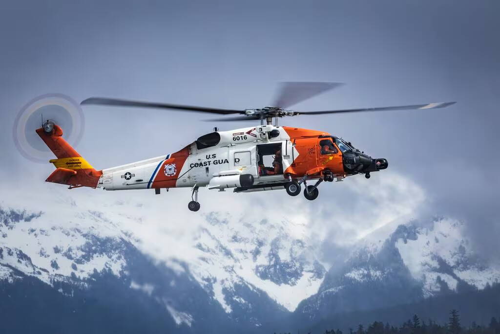 A U.S. Coast Guard Air Station Sitka helicopter hovers over Sitka Sound during routine hoist training on April 25. (Lt. Cmdr. Wryan Webb/Coast Guard)