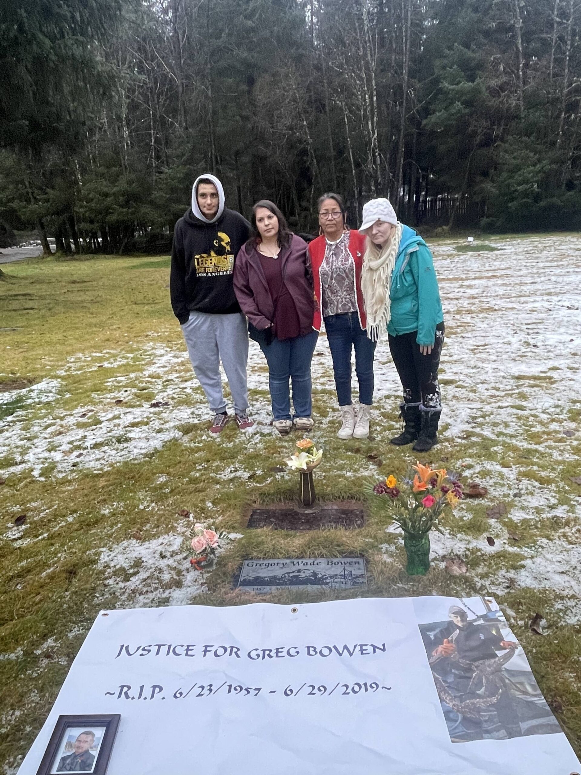 Gregory Bowen’s family — Wade Bowen, Alexandria Roehl, Mabel Pittman, Alexandra Pittman — seen here at his marker at Alaskan Memorial Park and Legacy Funeral Homes after the verdict Friday in the trial of Sonya Taton, who was convicted of stabbing Bowen to death. Pittman had the banner redone before the trial started. (Photo by Jack Tullis, courtesy of Mabel Pittman.)
