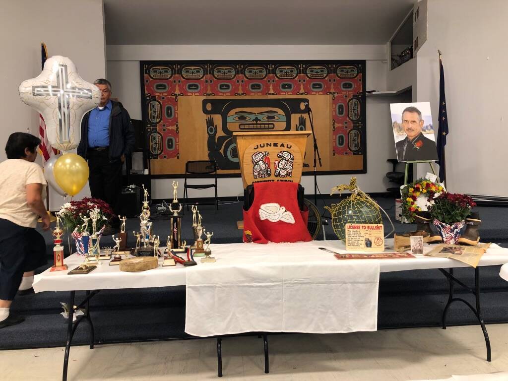 The table set up for the service of Greg Bowen on July 12, 2019, at Juneau Tlingit & Haida Community Center included trophies and mementos from other aspects of life. (Photo courtesy of Barbara Cadiente-Nelson.)