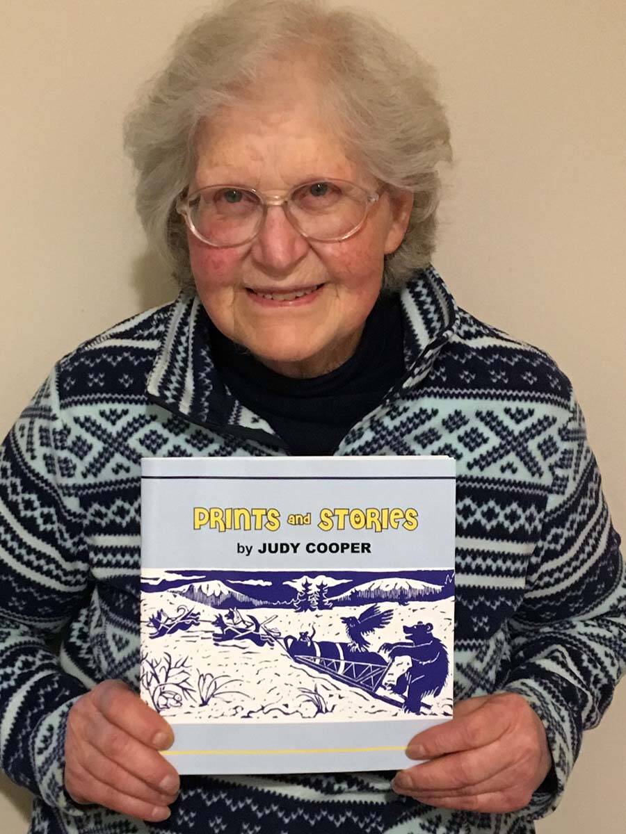 Judy Cooper, a former longtime vendor at the Juneau Public Market who died in April, shows a book of her art and stories. This year’s market is being dedicated in her memory. (Courtesy of Juneau Public Market)