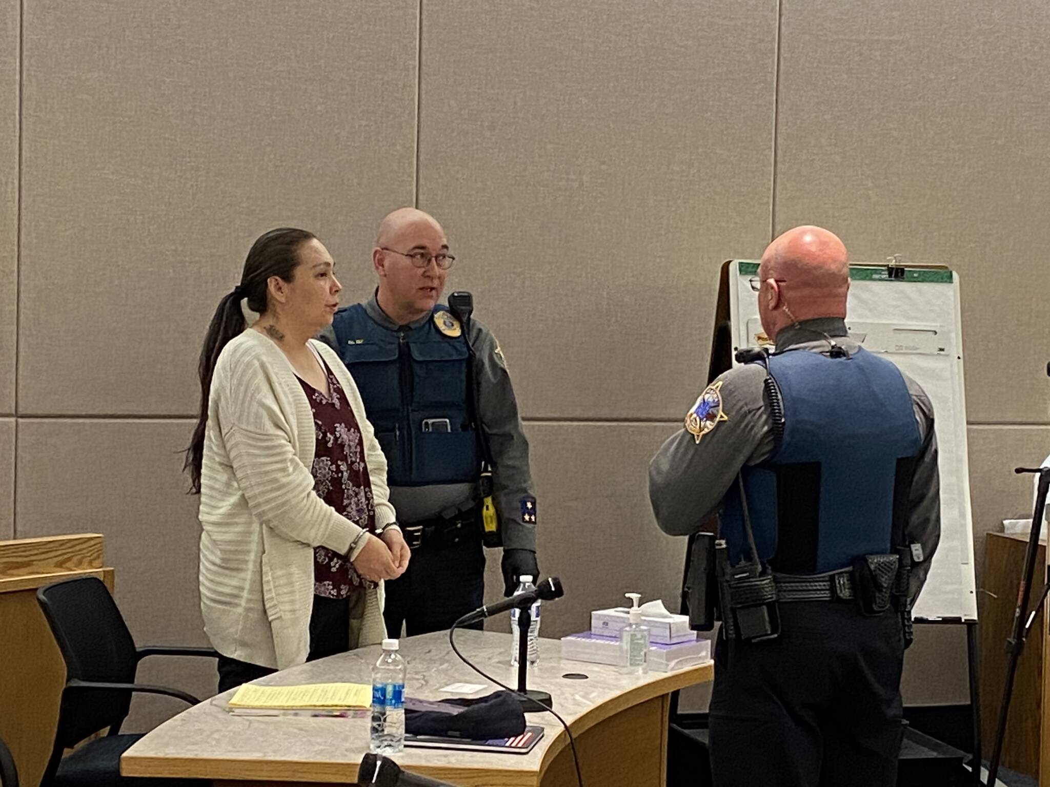 Sonya Taton, left, is handcuffed following her conviction on five counts, including second-degree murder, Friday in Superior Court in Juneau. (Meredith Jordan / Juneau Empire)