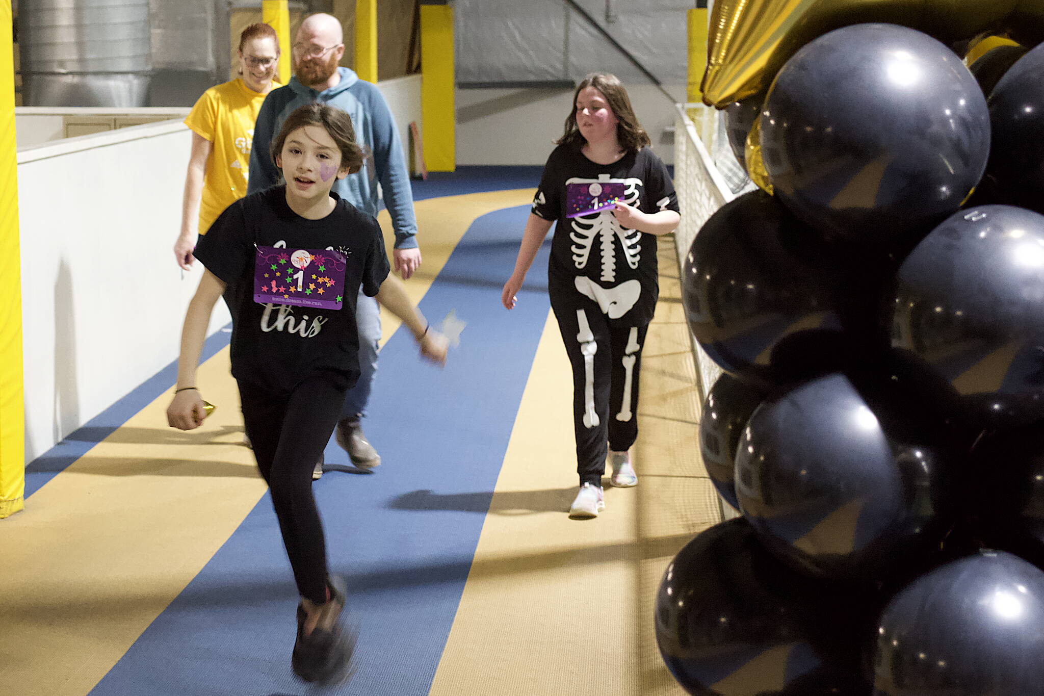 Mark Sabbatini / Juneau Empire
Casey Blackwell, 10, crosses the finish line after running 27 laps around the indoor track at Dimond Park Field House to complete the 5K Pajama Jog on Sunday.