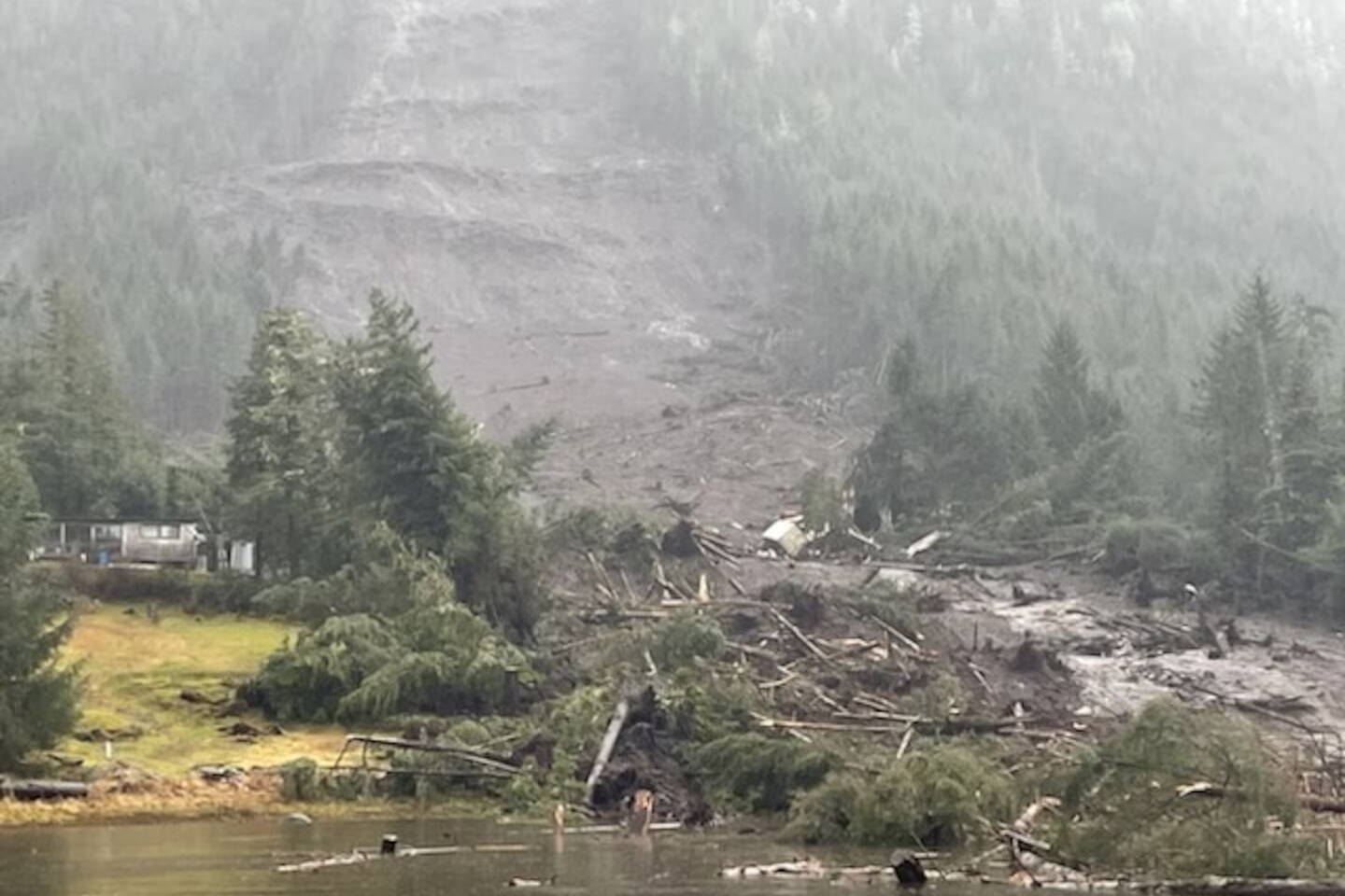 Debris from a massive landslide on Monday night extends into the sea at mile 11 on Zimovia Highway in Wrangell. Three people were killed and three more people are missing as of 5:15 p.m. Tuesday by the landslide that impacted three single-family homes, according to officials. (U.S. Coast Guard)