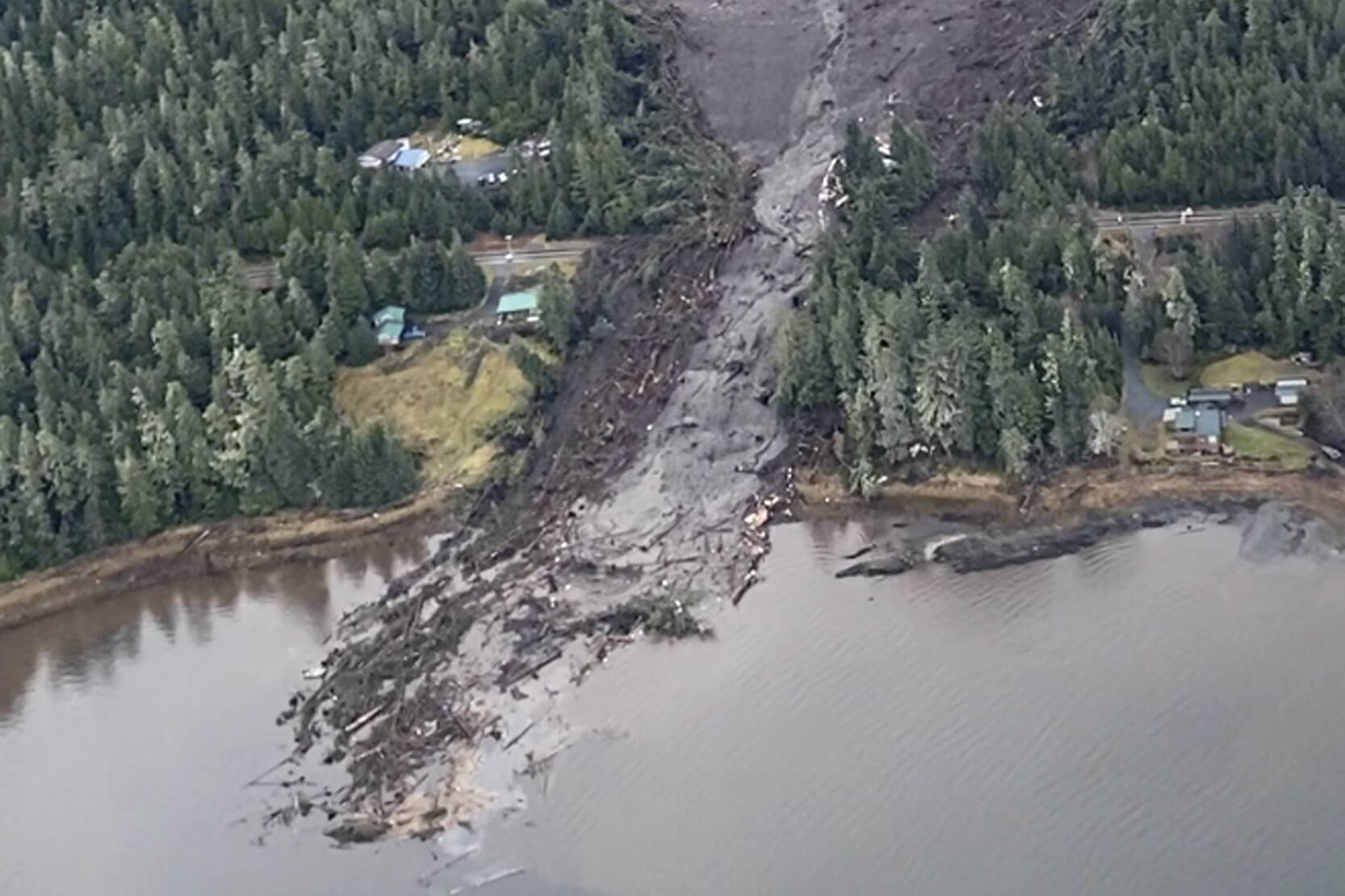 This image from video provided by Sunrise Aviation shows the landslide that occurred the previous evening near Wrangell on Monday. Authorities said at least one person died and others were believed missing after the large landslide roared down a mountaintop into the path of three homes. (Sunrise Aviation via AP)
