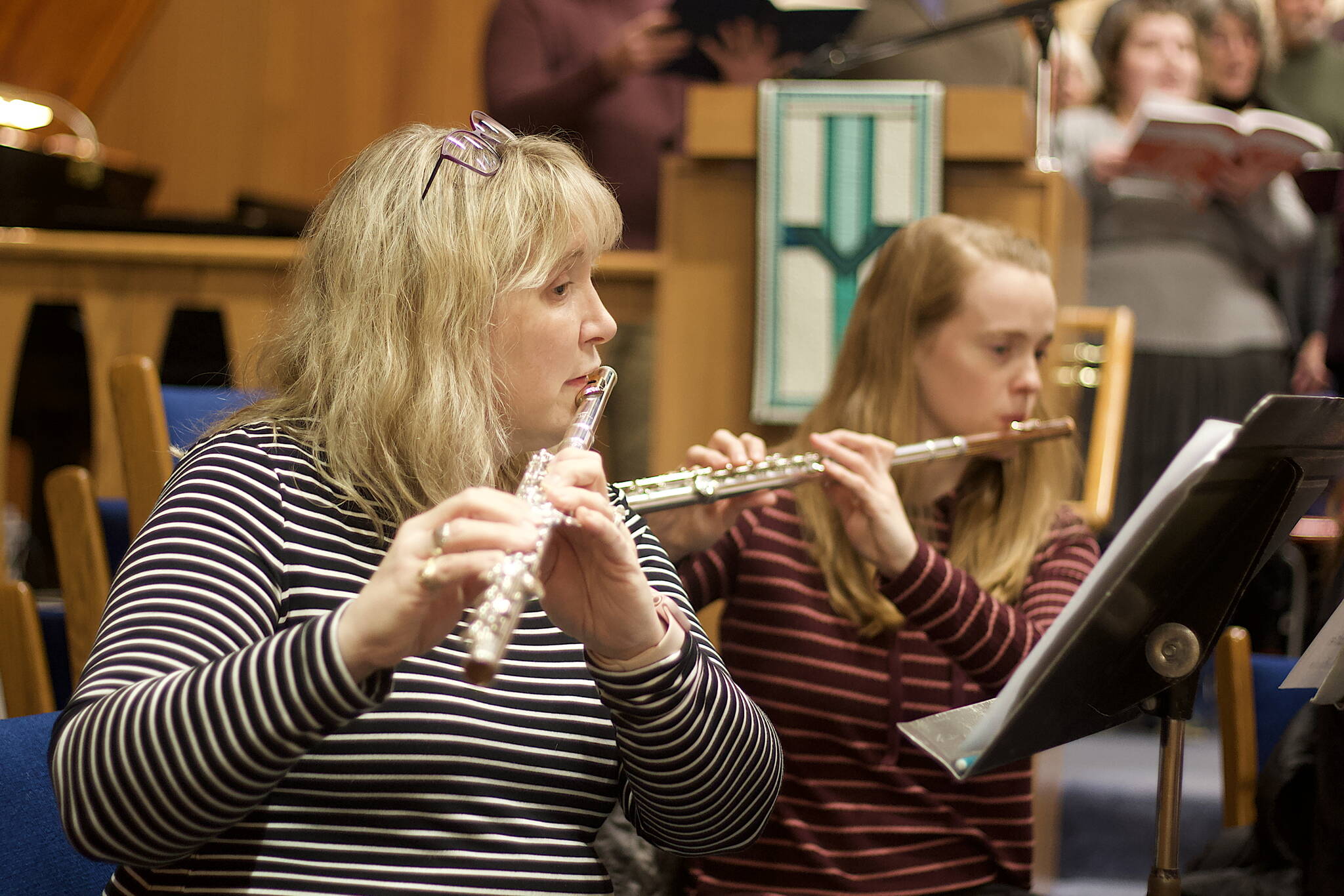 Colleen Torrence (left) and Inga White use flutes to play portions of Handel’s “Messiah” traditionally played by violins in a re-orchestration of the oratorio scheduled to be performed at Ḵunéix̱ Hídi Northern Light United Church at 7 p.m. Saturday and 3 p.m. Sunday. (Mark Sabbatini / Juneau Empire)