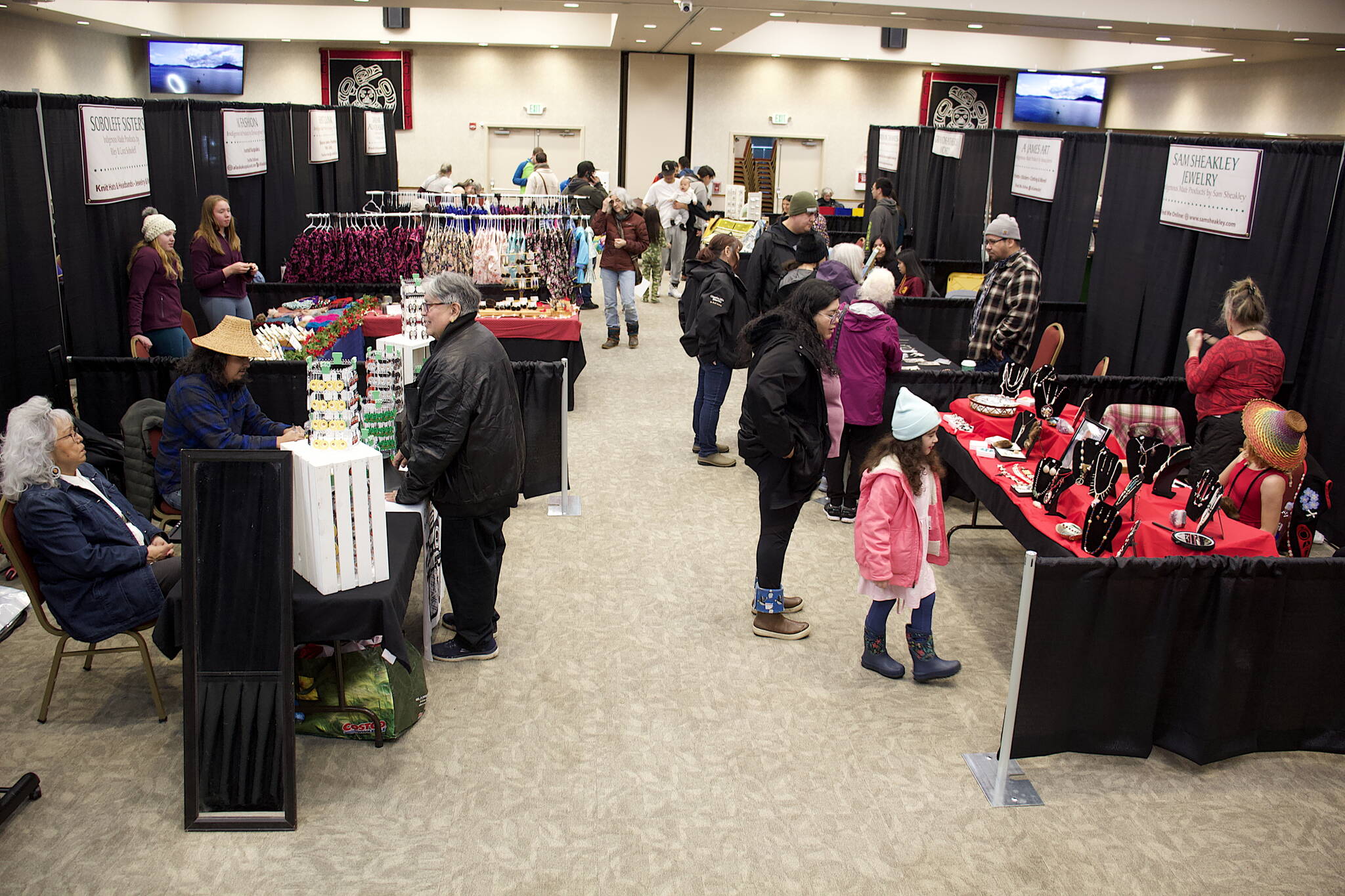 Shoppers browse the isles at the Indigenous Artists & Vendors Holiday Market at Elizabeth Peratrovich Hall on Friday. (Mark Sabbatini / Juneau Empire)