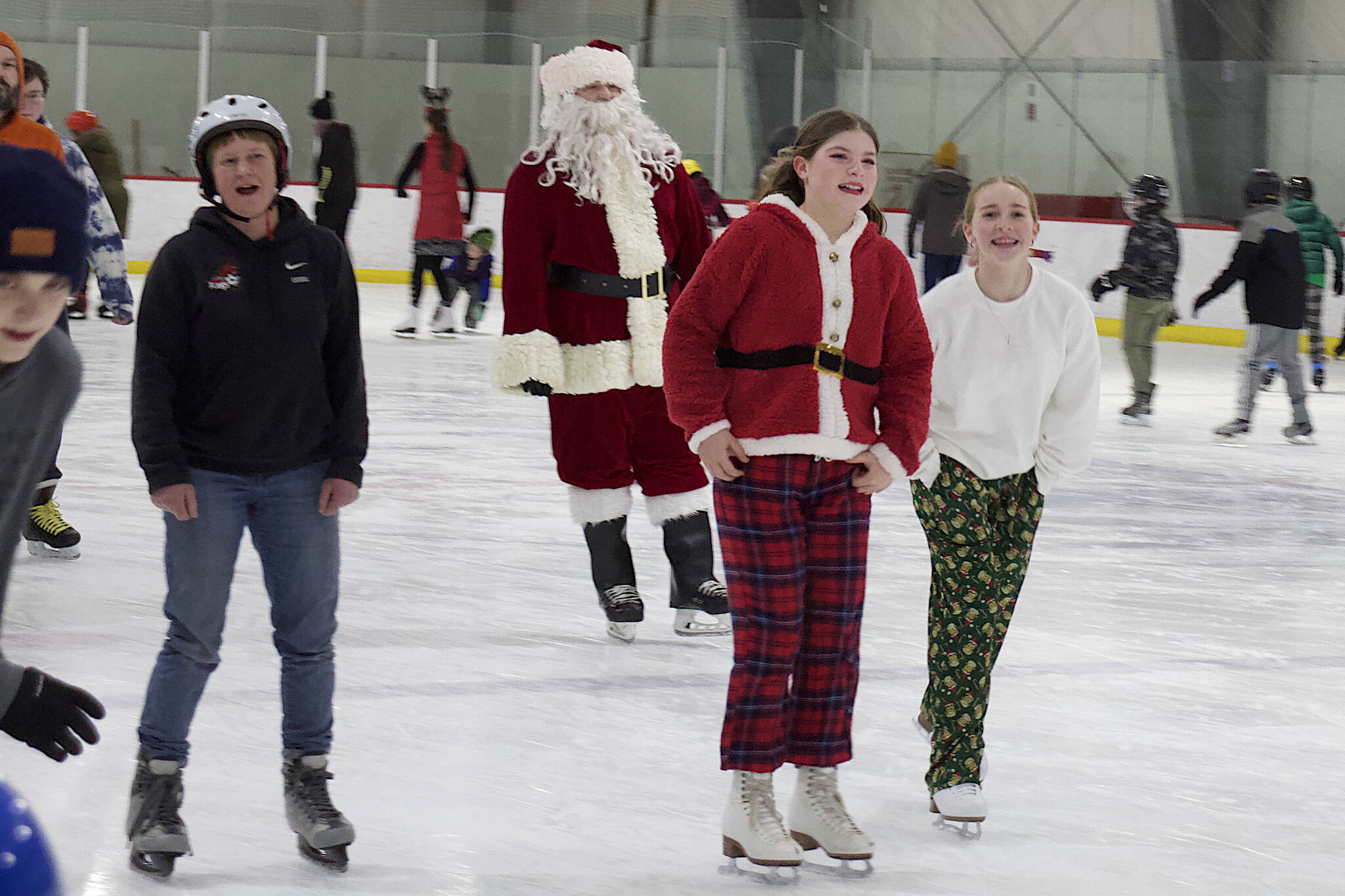 Santa joins other festively dressed skaters at Treadwell Arena on Friday night. (Mark Sabbatini / Juneau Empire)