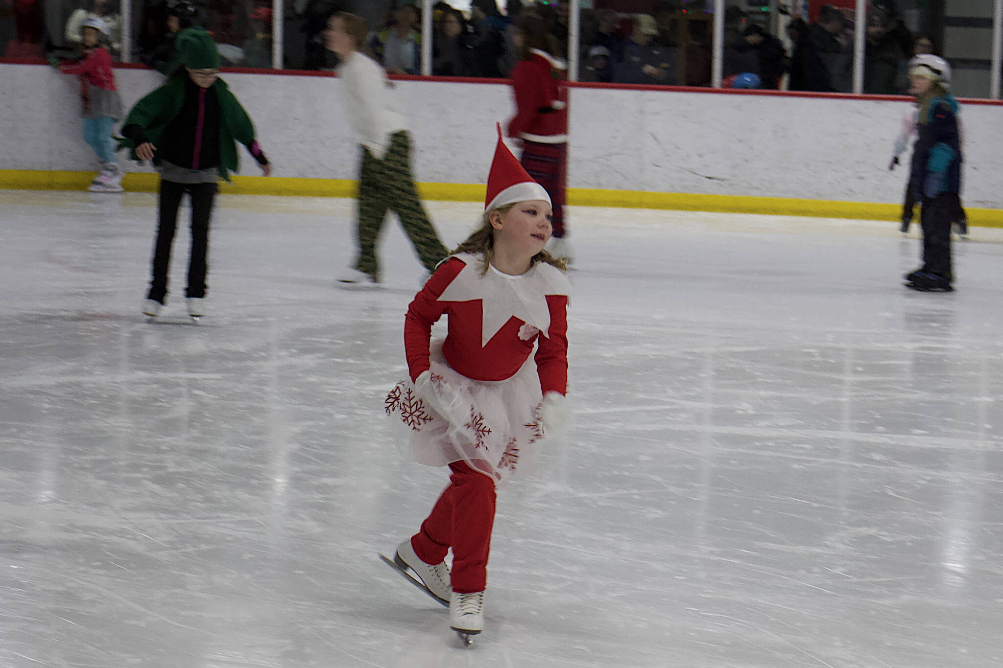 An energetic Santa’s helper speeds along the ice during the annual Santa Skate at Treadwell Arena on Friday night.(Mark Sabbatini / Juneau Empire)