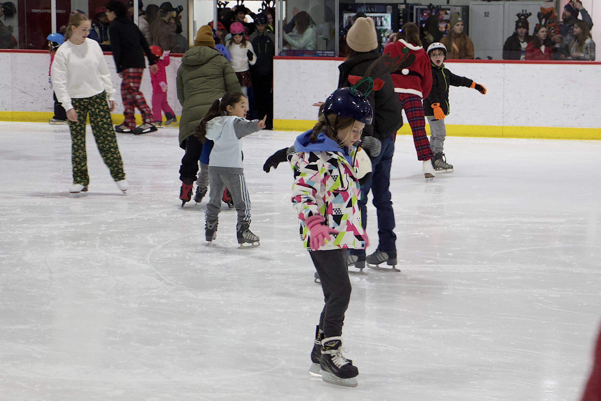 Skaters seek to find balance during the holiday season during the annual Santa Skate at Treadwell Arena on Friday night. (Mark Sabbatini / Juneau Empire)