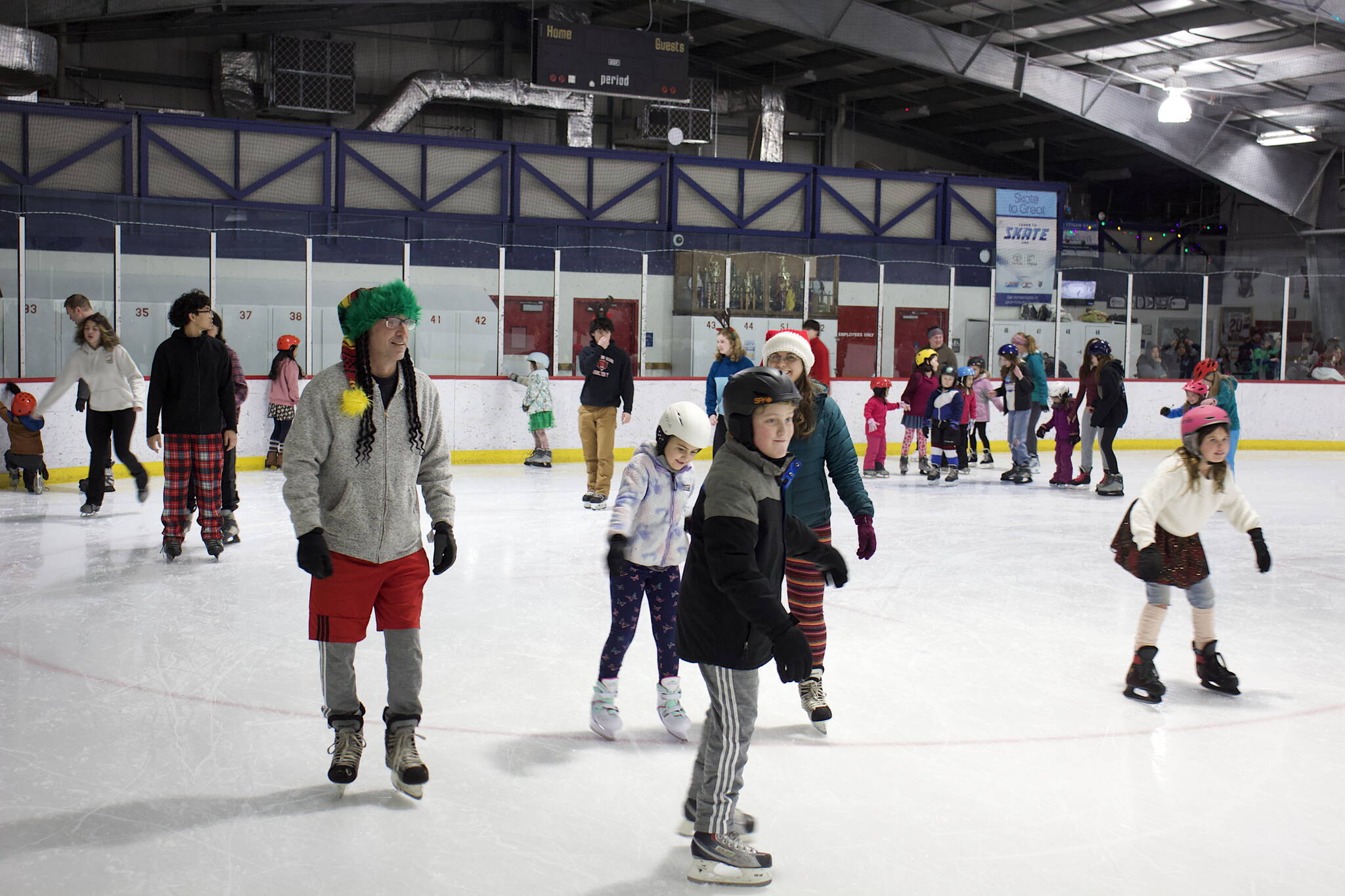 Hundreds of people pack into Treadwell Arena on Friday night for the annual Santa Skate. (Mark Sabbatini / Juneau Empire)