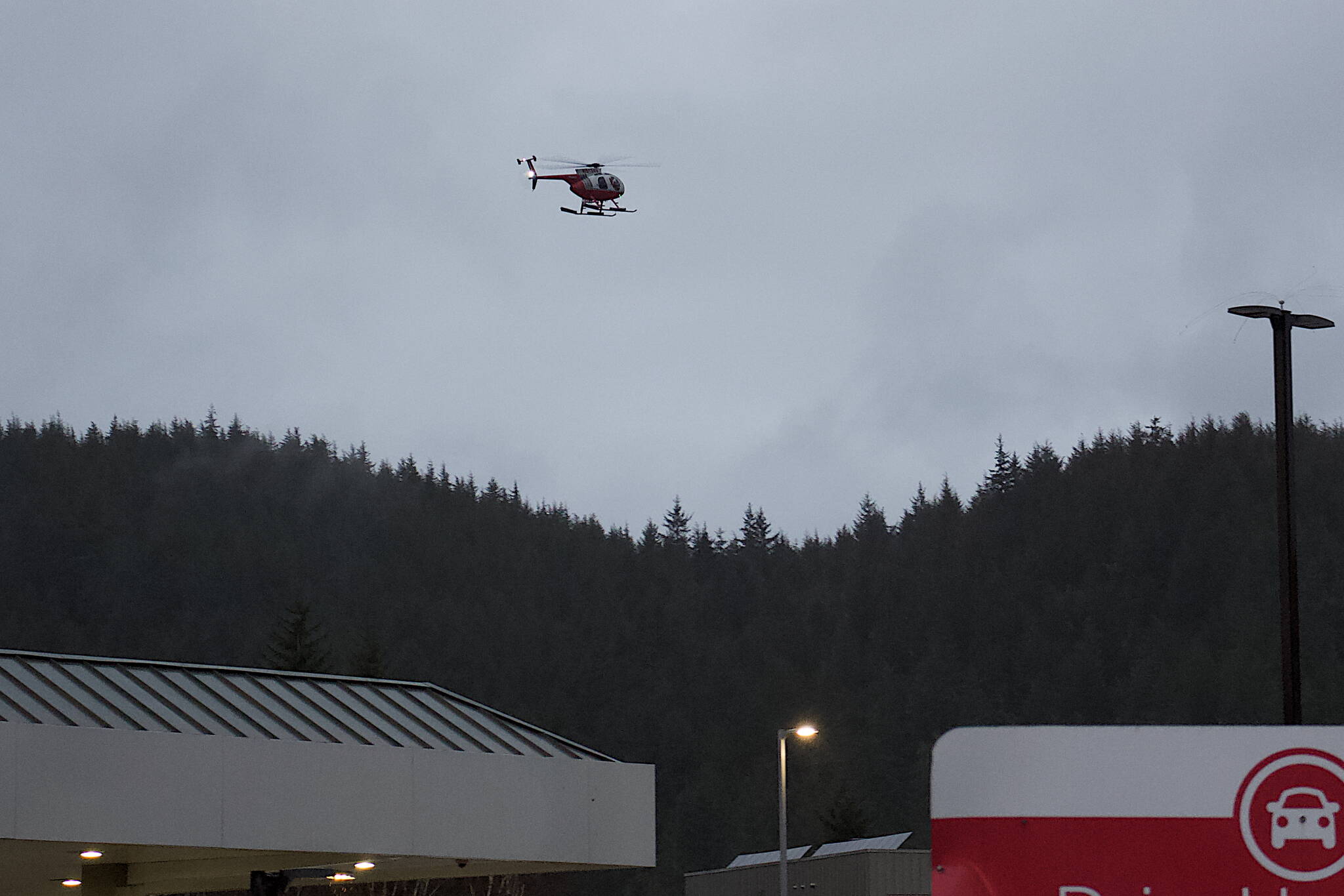 A search helicopter passes over the Mendenhall River area at mid-afternoon Sunday near Riverview Senior Living center, where resident Nathan Bishop, 58, was last seen early Saturday evening. About 70 people were involved in the search for him as of Sunday afternoon, according to officials. (Mark Sabbatini / Juneau Empire)
