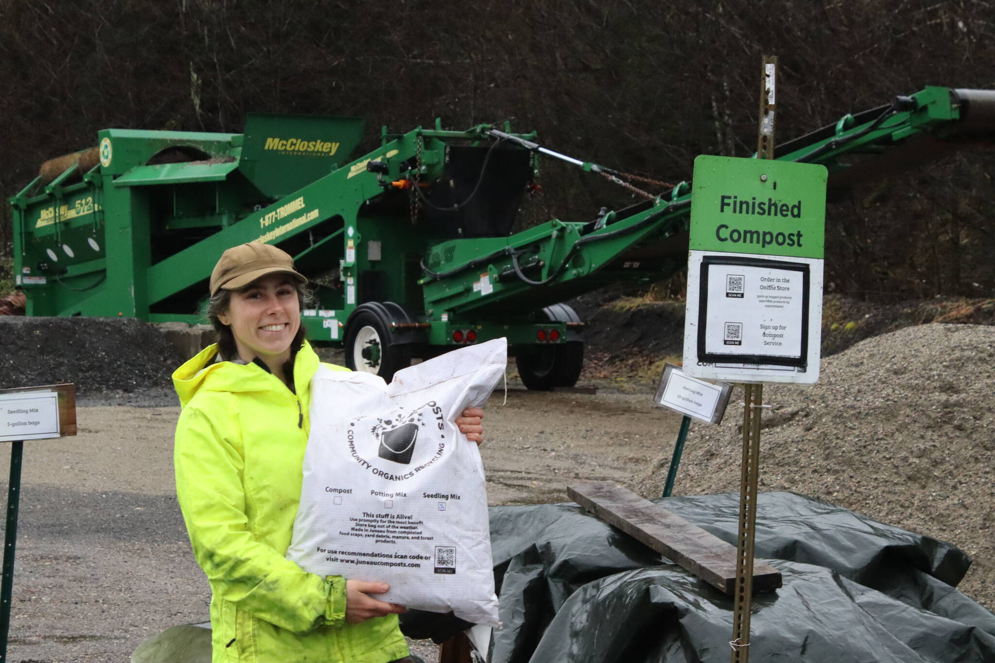 Lisa Daugherty, owner of Juneau Composts!, stands in front of a recently acquired trommel screener, which separates different materials like soil, gravel, mulch and sand. She has invested $250,000 in the company since she started it in 2017. (Meredith Jordan/ Juneau Empire)