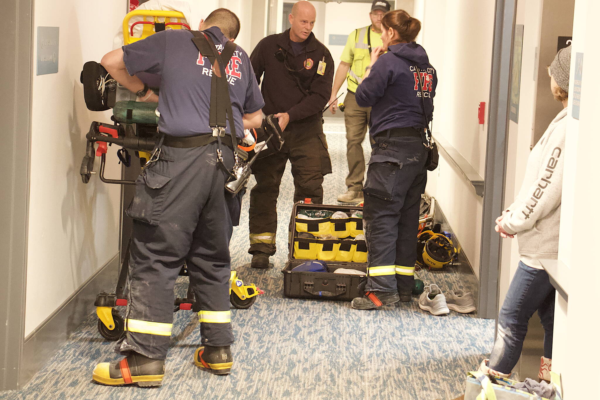 Capital City Fire/Rescue and other workers prepare a stretcher in a hallway of the Riverview Senior Living Center for Nathan Bishop, 58, after he was found late Monday morning in the attic about 40 hours after he was reported missing. (Mark Sabbatini / Juneau Empire)