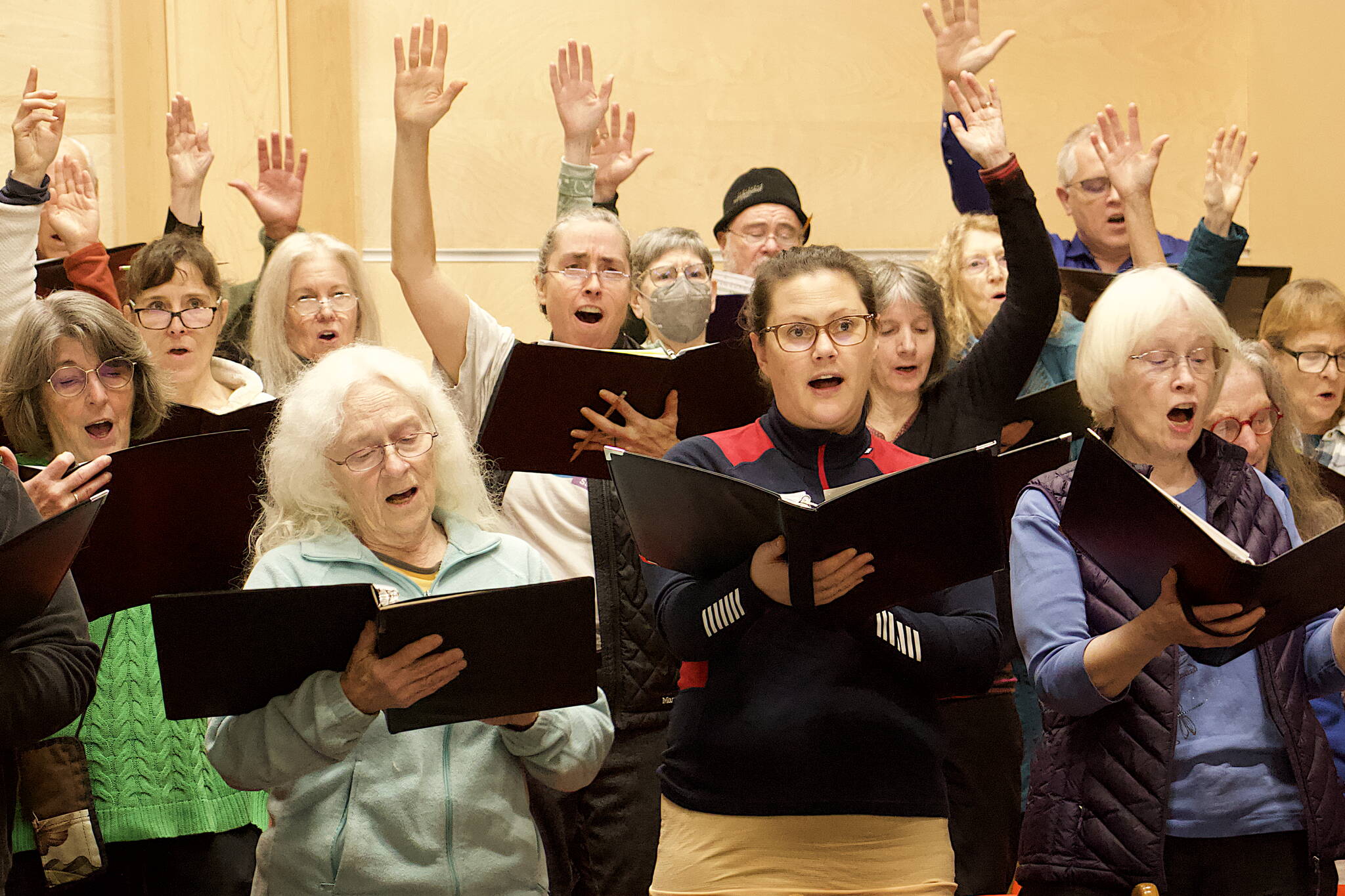 Choir members rehearse Tuesday night for a Bach holiday concert at Ḵunéix̱ Hídi Northern Light United Church. (Mark Sabbatini / Juneau Empire)