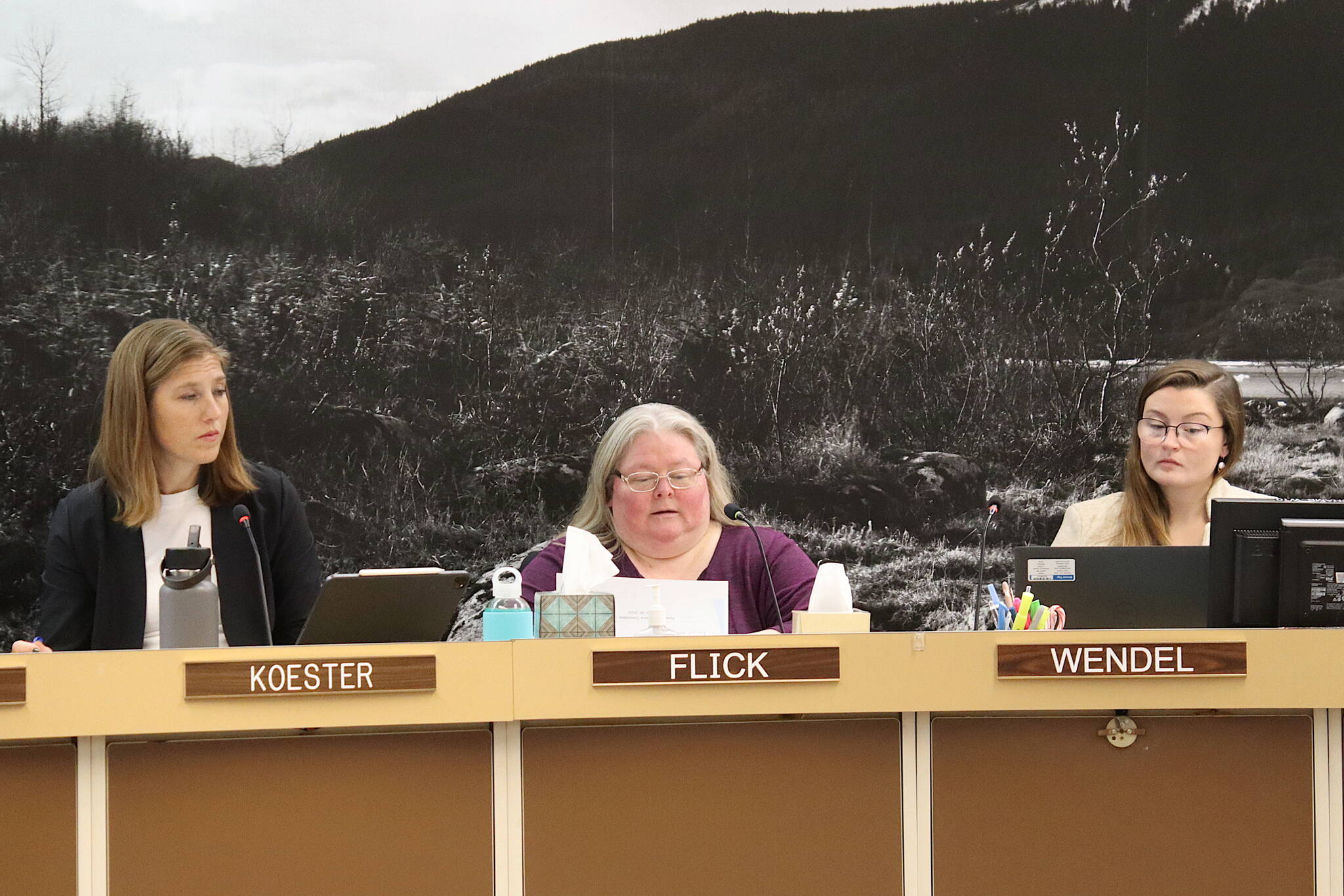 Angie Flick (center), finance director for the City and Borough of Juneau, provides details of an early draft of next year’s municipal budget to Assembly members as City Manager Katie Koester (left) and Budget Manager Adrien Wendel listen during a Finance Committee meeting Wednesday night in the Assembly Chambers. (Mark Sabbatini / Juneau Empire)