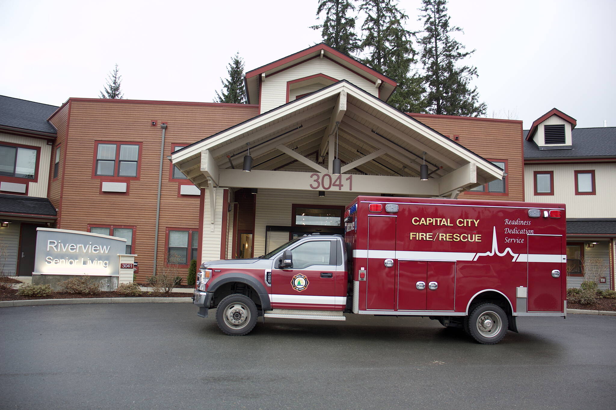 A Capital City Fire/Rescue truck parks outside the main entrance of the Riverview Senior Living complex Monday after Nathan Bishop, 58, is found alive in the attic 40 hours after being reported missing from the facility where he is a resident. (Mark Sabbatini / Juneau Empire)