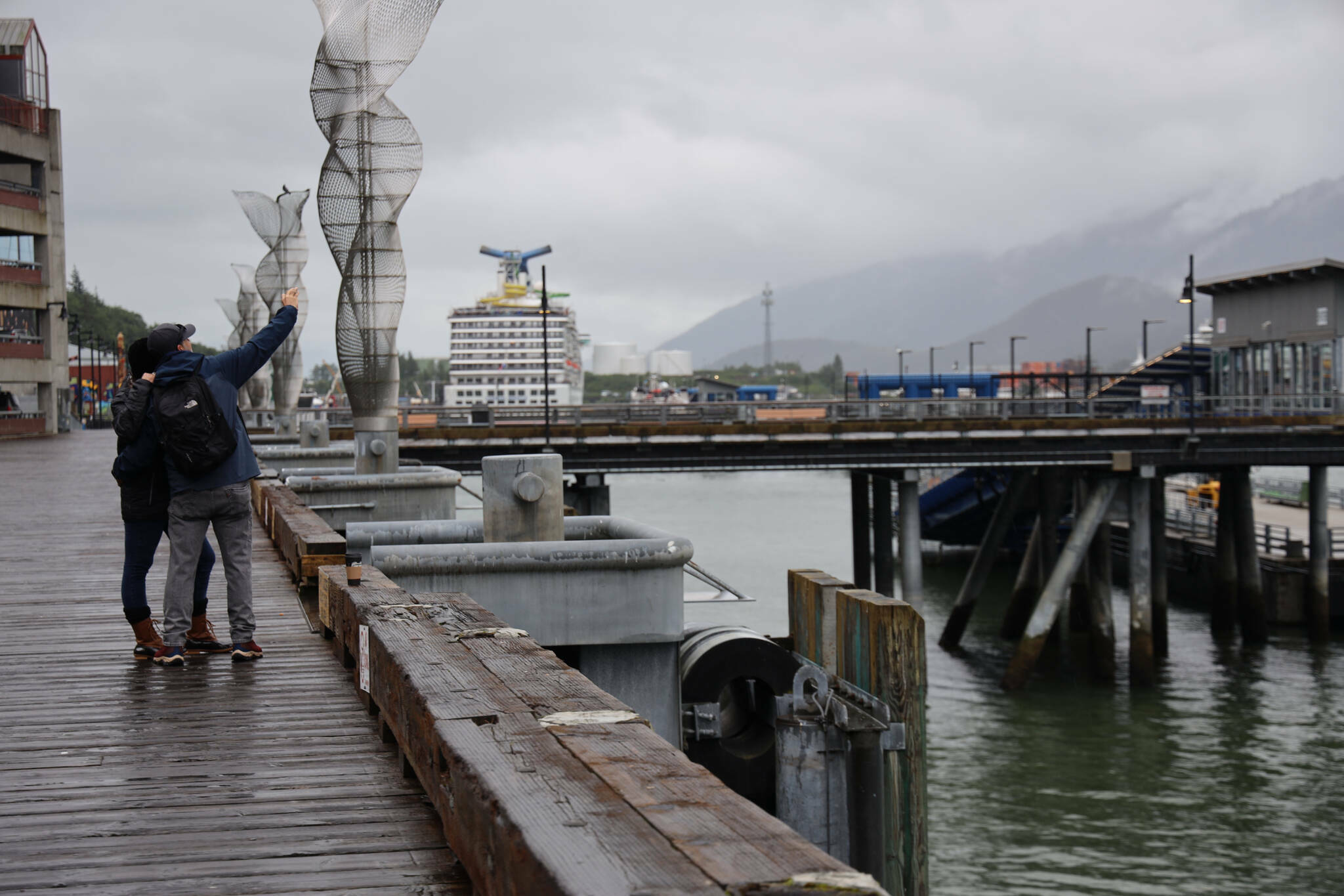 Visitors take a selfie on the downtown cruise ship docks in July. (Clarise Larson / Juneau Empire file photo)