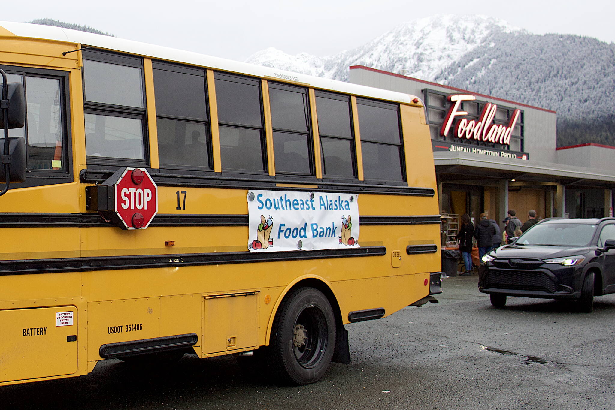 A bus parks outside the entrance of Foodland IGA during the Southeast Alaska Food Bank’s annual Caring is Sharing Food Drive on Nov. 18. (Mark Sabbatini / Juneau Empire file photo)