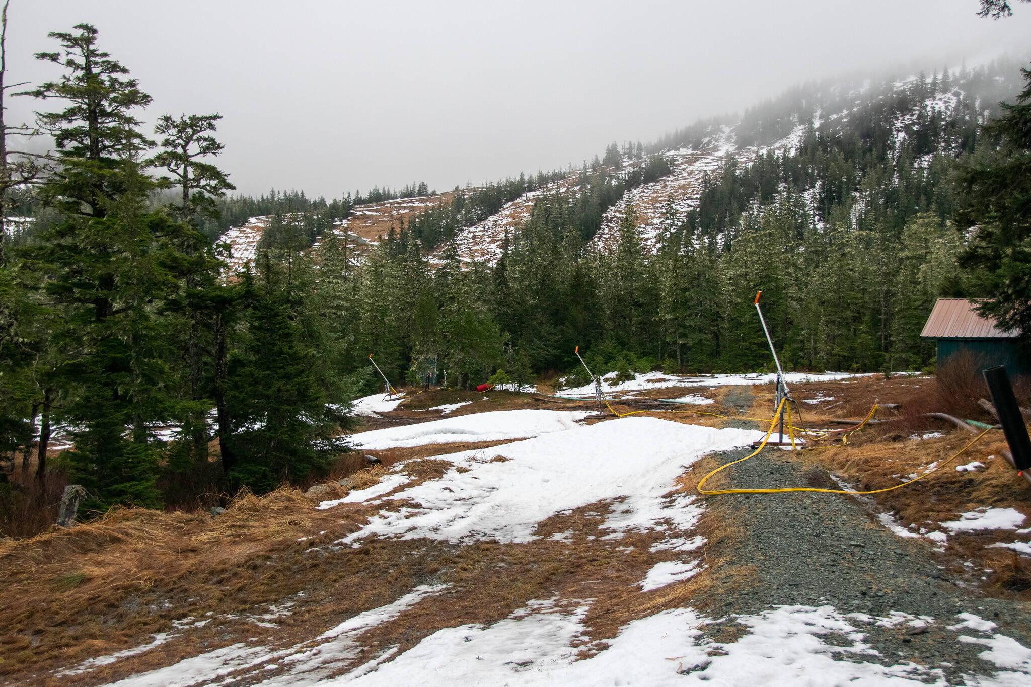 Scant patches of snow remain at the base of Eaglecrest Ski area on Wednesday despite snowmaking efforts that occurred during the weekend, due to warmer temperatures and rain this week. The opening date for the ski area, originally set for Dec. 2 and then delayed until Dec. 9, is now undetermined. (Photo courtesy of Eaglecrest Ski Area)