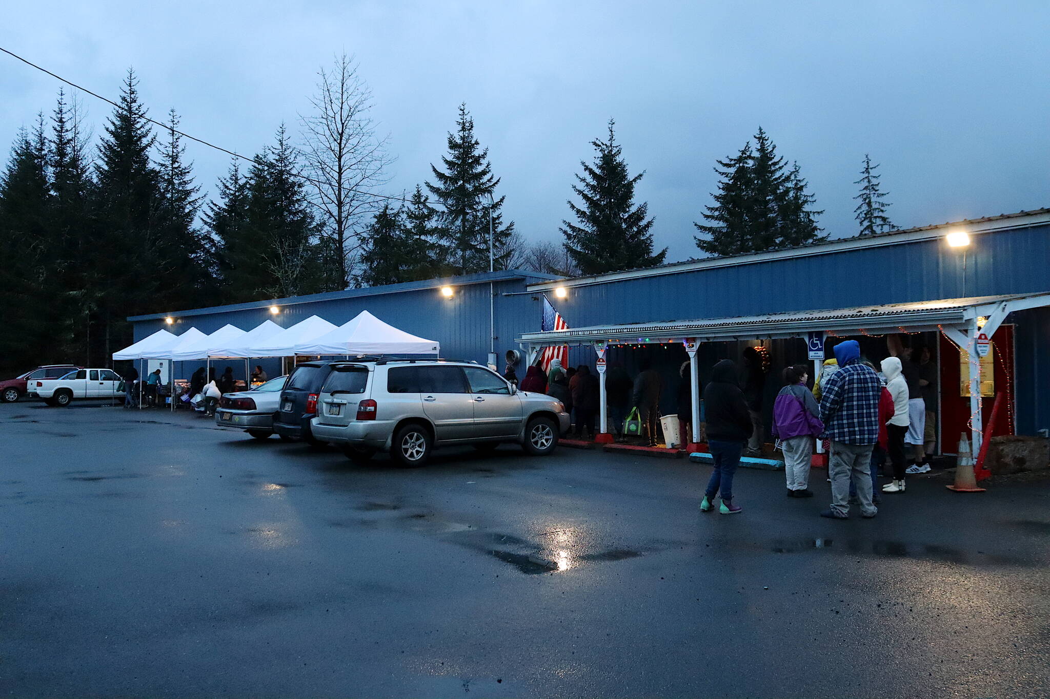 A long line of people wait their turn during the Southeast Alaska Food Bank’s weekly food pantry on Thursday. Staff at the food bank say such lines are a “new normal” due to the season, issues with people getting public assistance and other factors. (Mark Sabbatini / Juneau Empire)