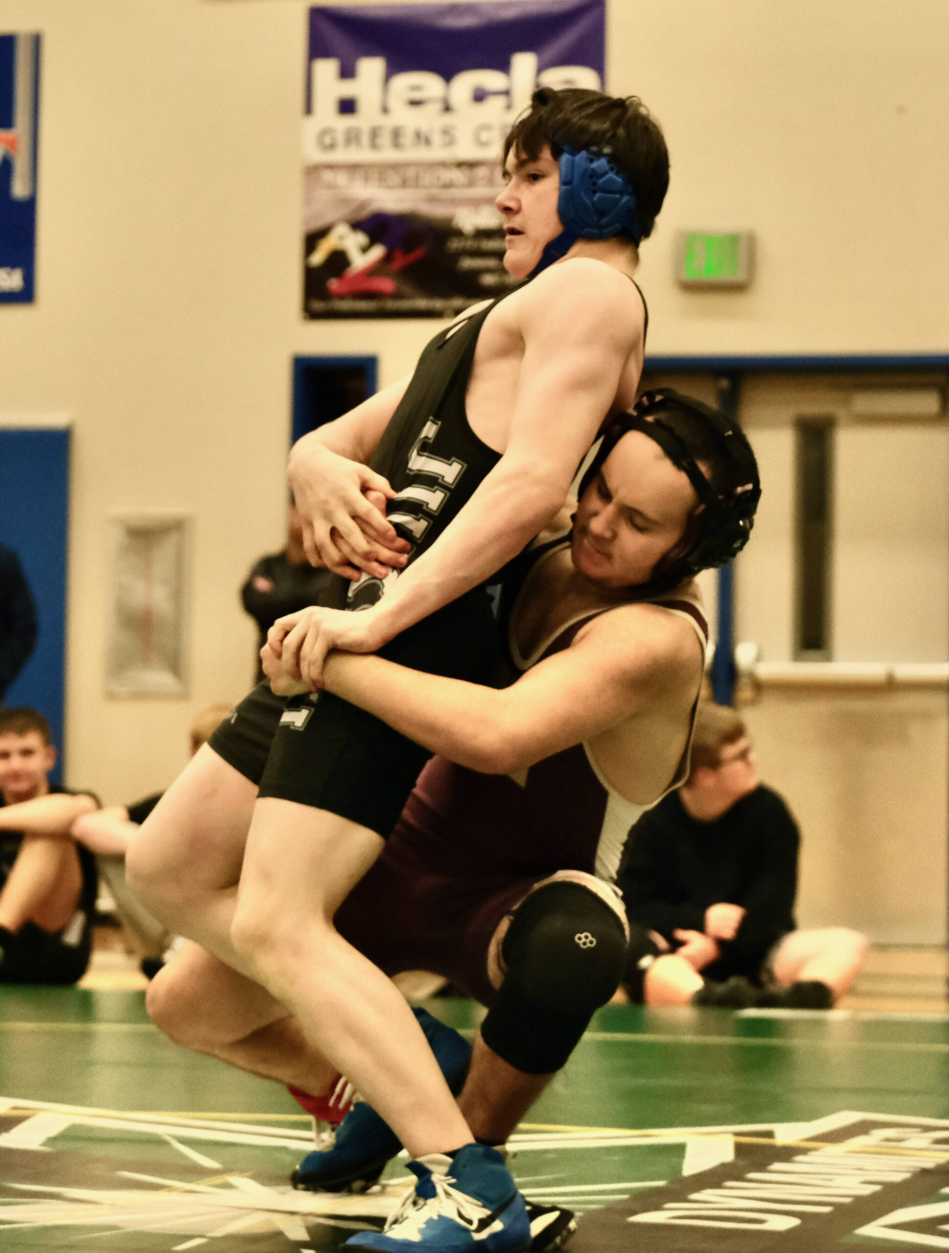Thunder Mountain High School sophomore Wyatt Kenny escapes from Ketchikan freshman Russell Page during their 160-pound opening round match of the 2023 Region V Wrestling Championships on Friday at TMHS. Kenny won by fall. (Klas Stolpe / For the Juneau Empire)