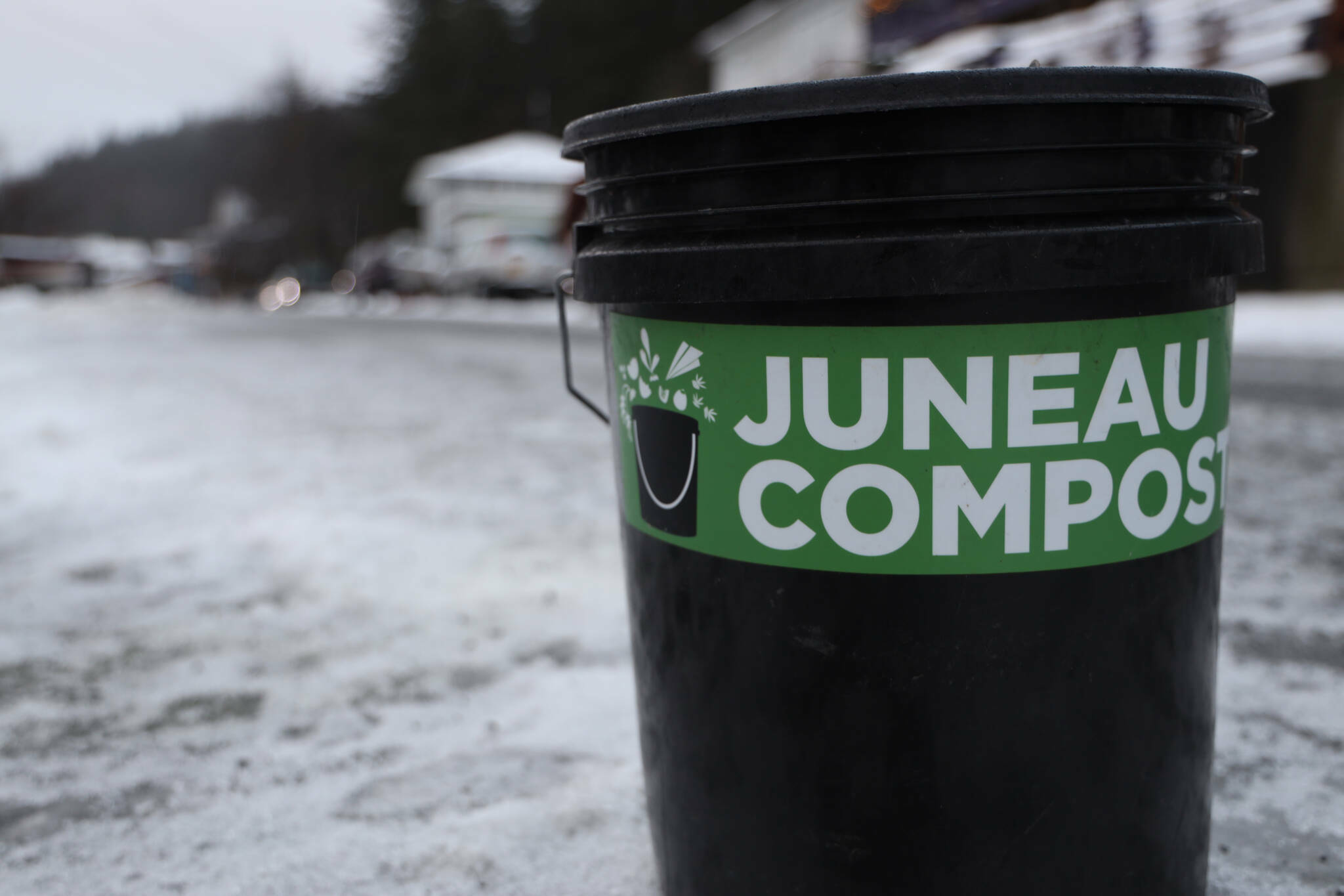 A bucket of compost awaits pickup by Juneau Composts on Douglas in December of 2022. (Clarise Larson / Juneau Empire file photo)