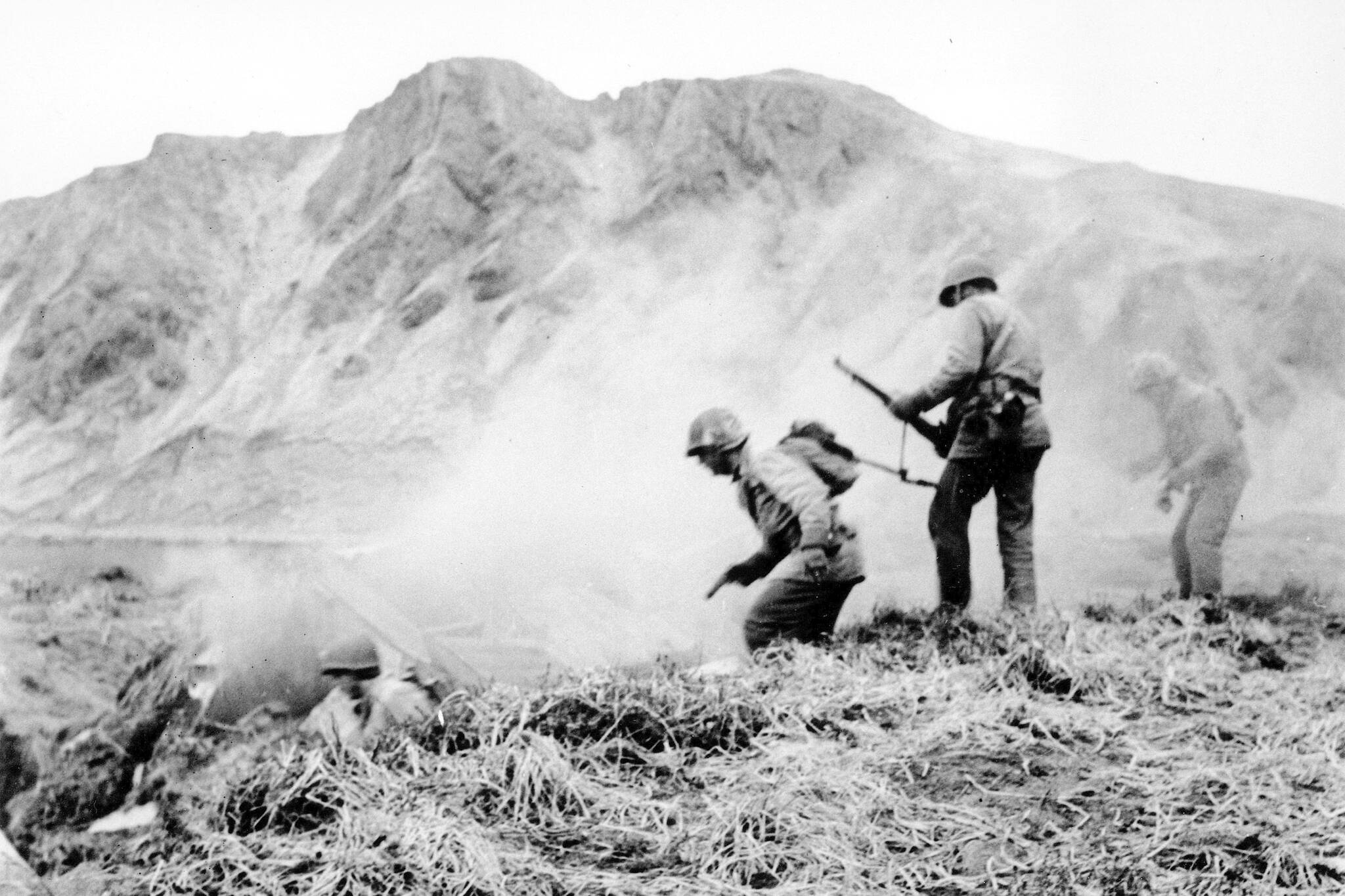 A U.S. squad armed with guns and hand grenades closes in on Japanese holdouts entrenched in dugouts during World War II on Attu Island, Alaska, in June 1943. Gregory Golodoff, who was 3 years old when his remote Alaska island was captured by Japanese troops and who became the last survivor among its 41 residents sent to Japan as prisoners, has died. The island of Attu in the Aleutian chain was one of just a few U.S. territories taken by enemy forces during the war, and the American effort to reclaim it amid frigid rain, dense fog and hurricane-force winds was the only battle of the war fought on North American soil. (U.S. Army via AP, File)