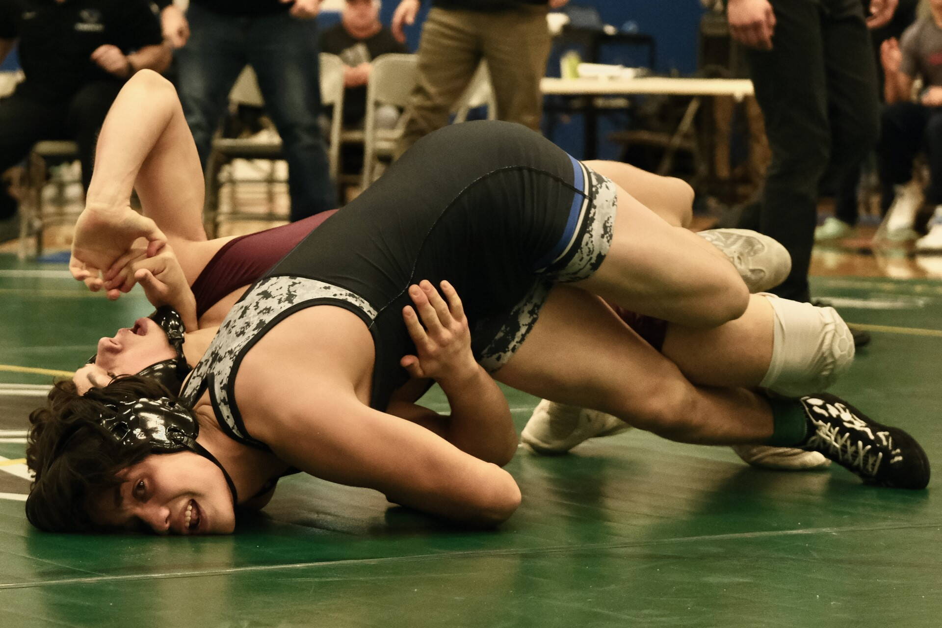 Thunder Mountain High School junior Hayden Aube attempts to pin Ketchikan High School sophomore Cayden Harney in the 145-pound Division I championship match of the 2023 ASAA Region V wrestling tournament Saturday at TMHS. Aube won by 16-6 major decision. (Klas Stolpe/ For the Juneau Empire)