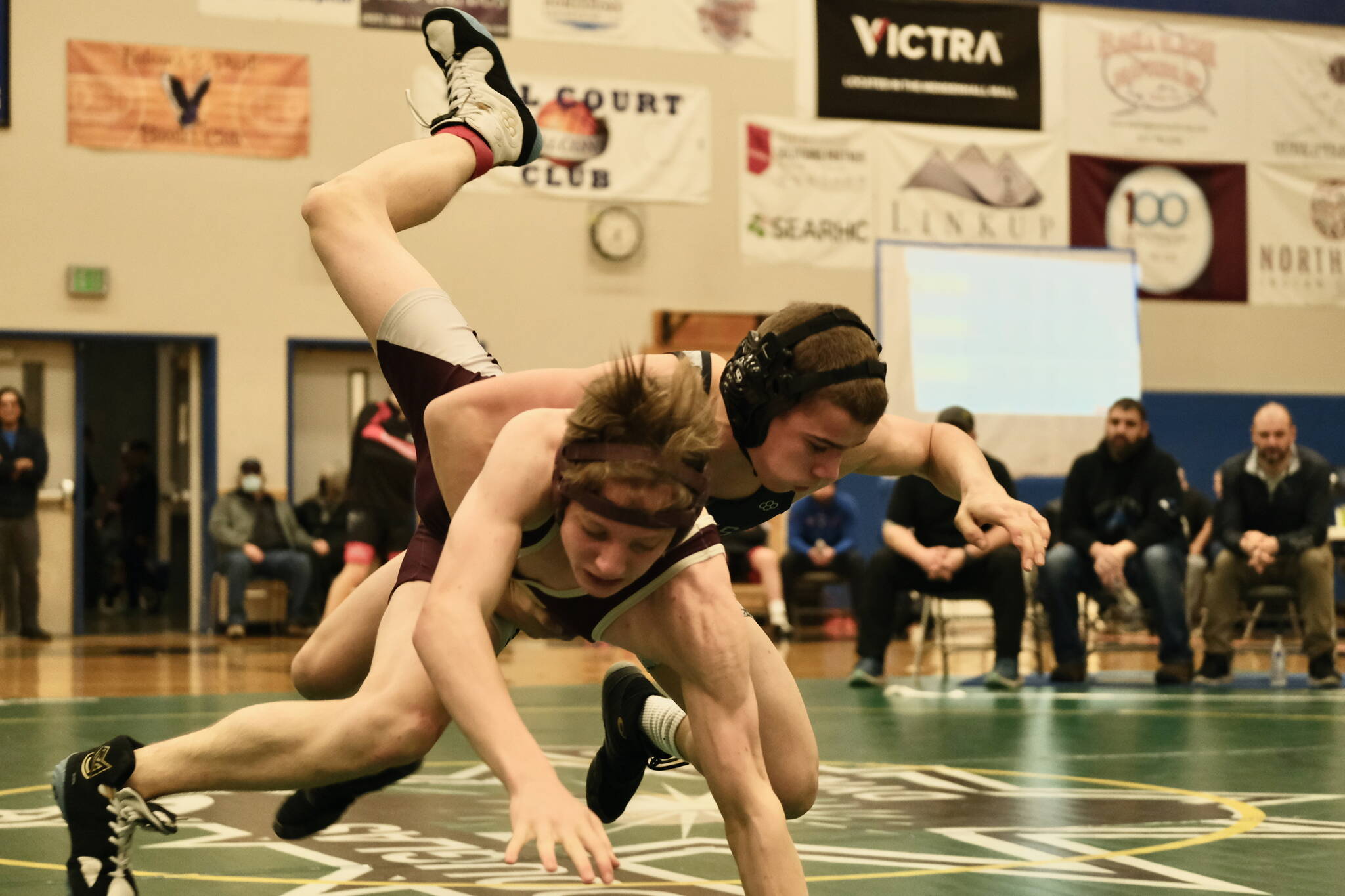 Thunder Mountain High School grappler Jed Davis, a Juneau-Douglas High School: Yadaa.at Kalé freshman, takes down Ketchikan High School sophomore Jack Styles in the 125-pound Division I championship match of the 2023 ASAA Region V wrestling tournament Saturday at TMHS. Davis won by fall. (Klas Stolpe/ For the Juneau Empire)