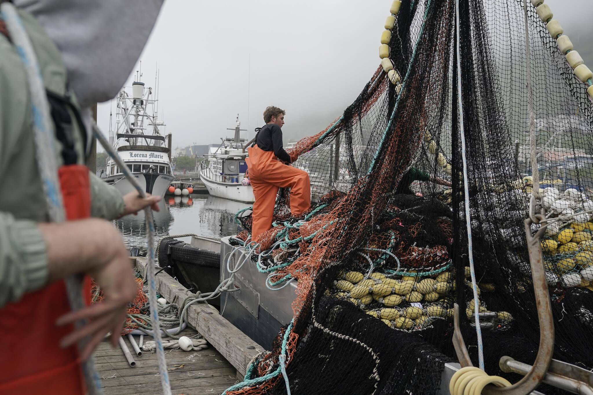 Deckhands stack nets on a boat before heading out to sea to fish salmon on Thursday, June 22, in Kodiak. (AP Photo/Joshua A. Bickel)