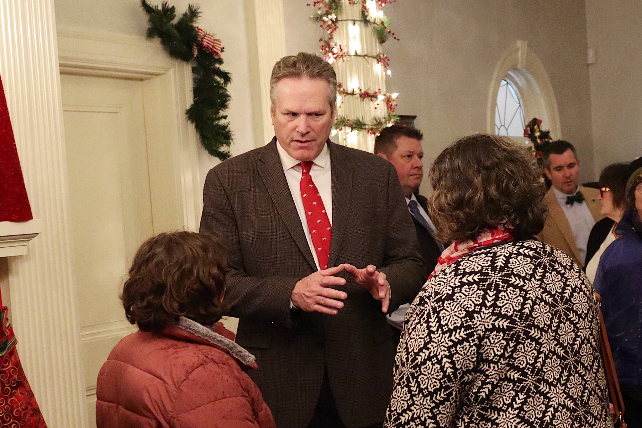 Gov. Mike Dunleavy greets visitors during the annual Holiday Open House at the Governor’s Residence on Tuesday. (Mark Sabbatini / Juneau Empire)