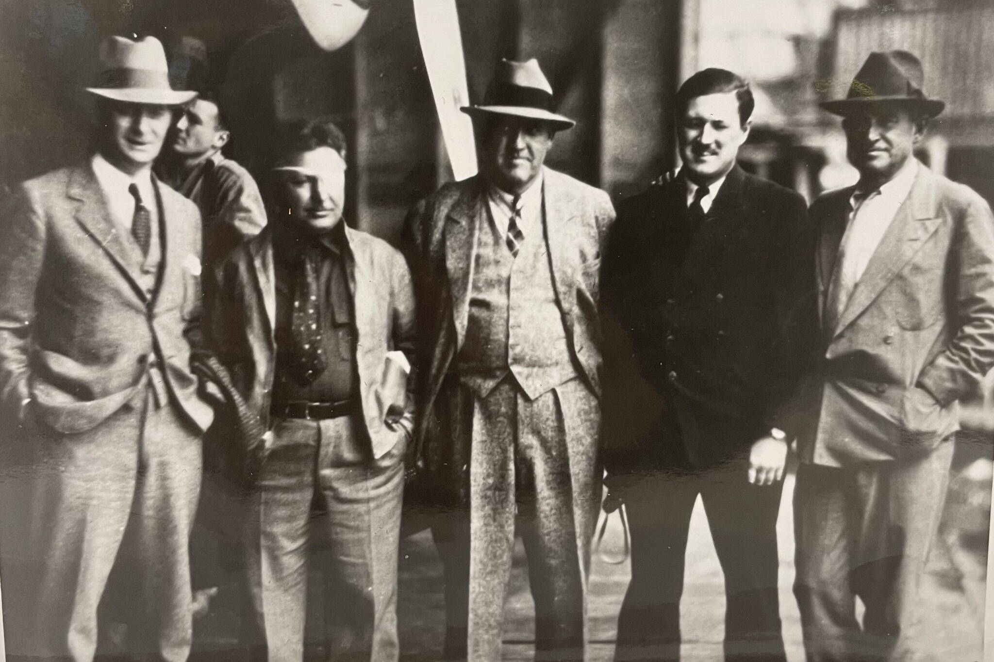 Five famous men stand together on a floatplane hangar deck on Aug. 8, 1935. From left to right: Juneau Mayor Izzy Goldstein, Pilot Wiley Post, Novelist Rex Beach, Pilot Joe Crosson, and “Cowboy Philosopher” Will Rogers. (Alaska State Library Ordway photo PCA-87-2631)