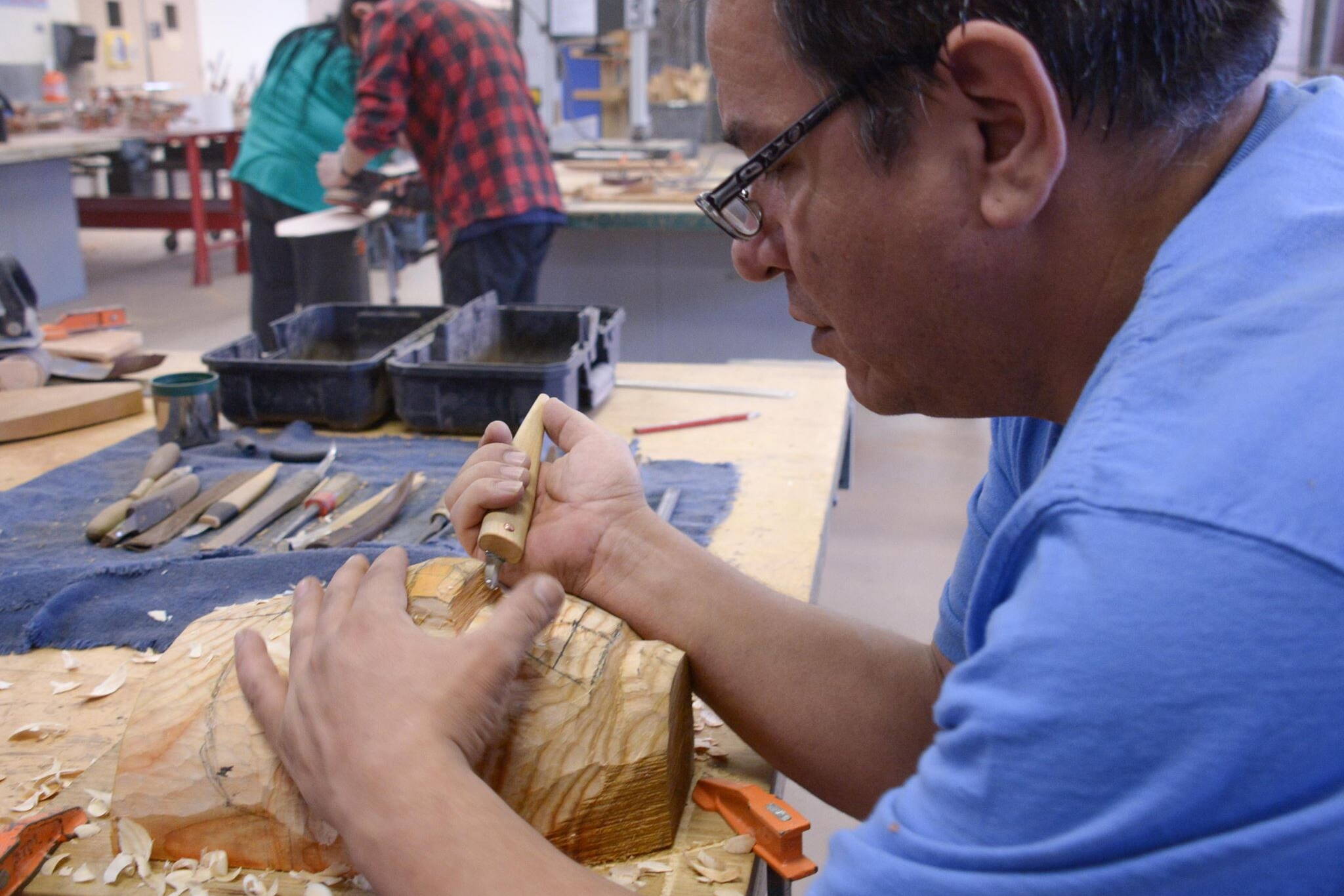 Doug Chilton works on a canoe journey carving at Juneau-Douglas High School: Yadaa.at Kalé in February of 2016. (Courtesy of the Central Council of the Tlingit and Haida Indian Tribes of Alaska)