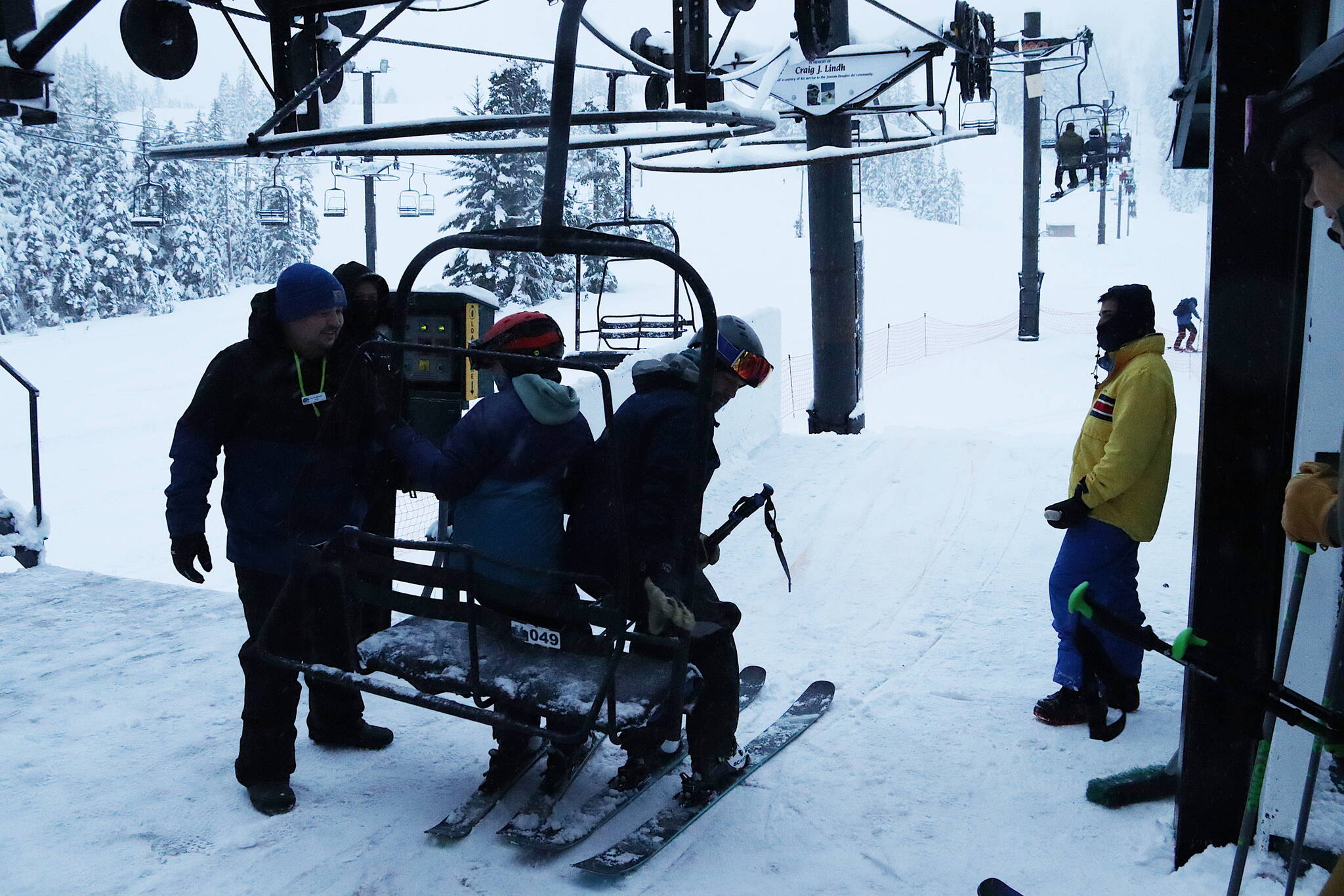 A pair of skiers are among the first to board the Ptarmigan lift on the first day of the 2023-24 season at Eaglecrest Ski Area shortly after 9 a.m. Wednesday. (Mark Sabbatini / Juneau Empire)