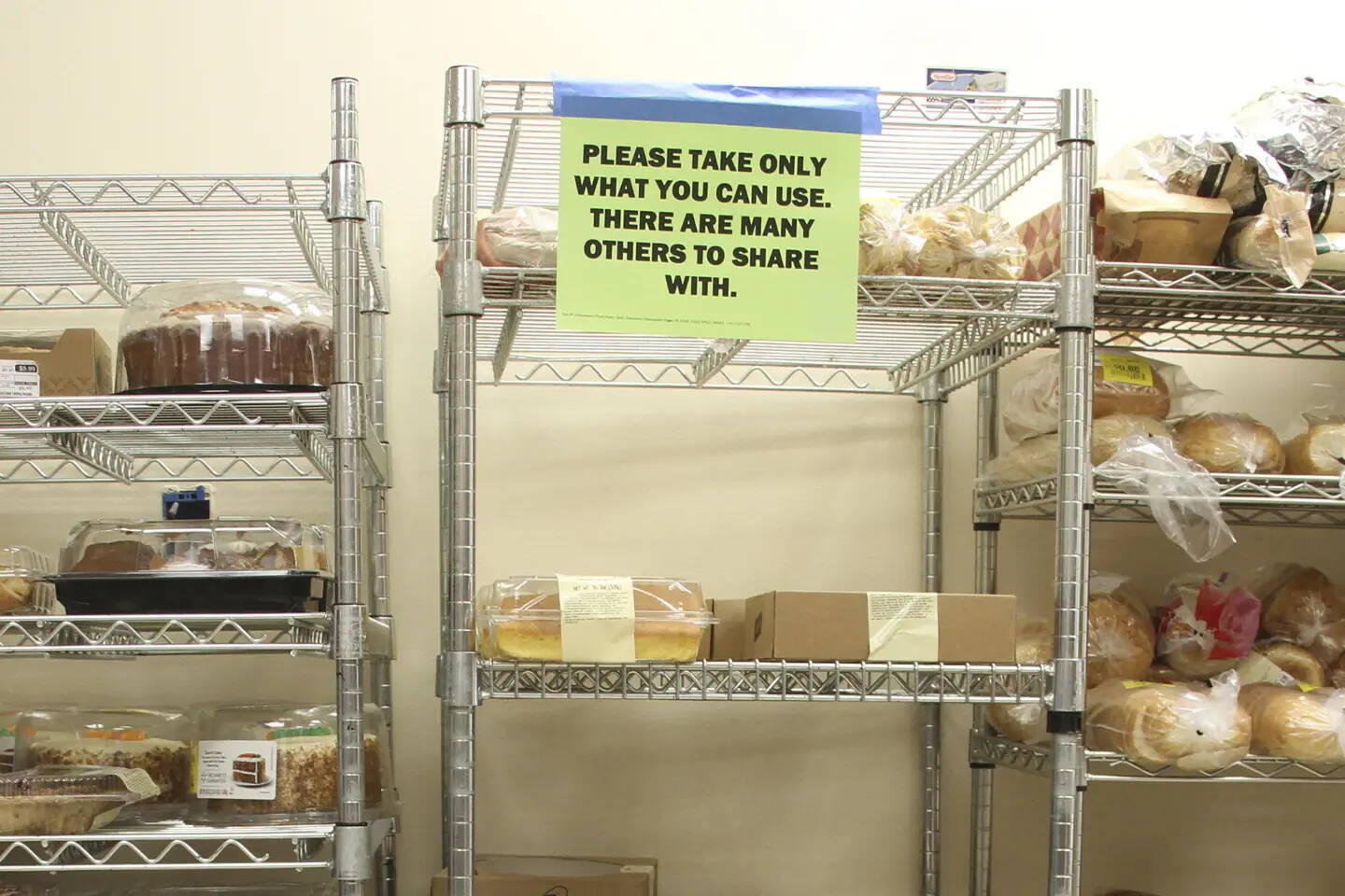 A sign asks visitors to exercise restraint at a food pantry in Eagle River on April 21, 2023. (Mark Thiessen / Associated Press file photo)