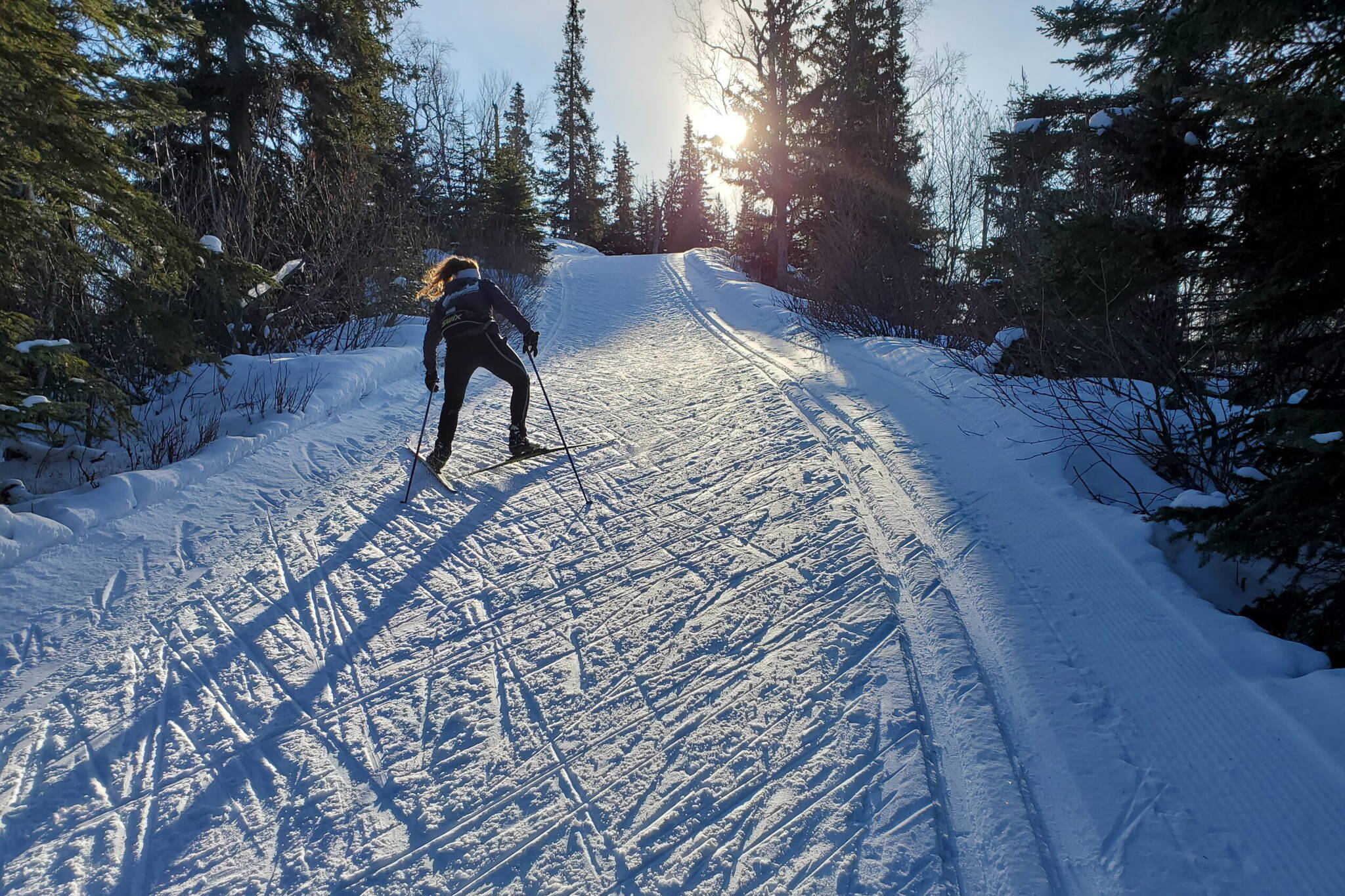 A skier skates on Feb. 28, 2021 to the high point of the Spencer Loop trail in the Hillside neighborhood of Anchorage. (Photo by Yereth Rosen/Alaska Beacon)