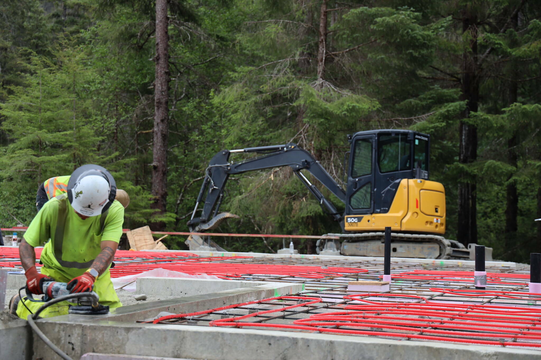 A worker uses machinery while working on the construction site of Central Council of Tlingit and Haida Indian Tribes of Alaska’s revived Haven House on July 31, 2023. (Clarise Larson / Juneau Empire file photo)
