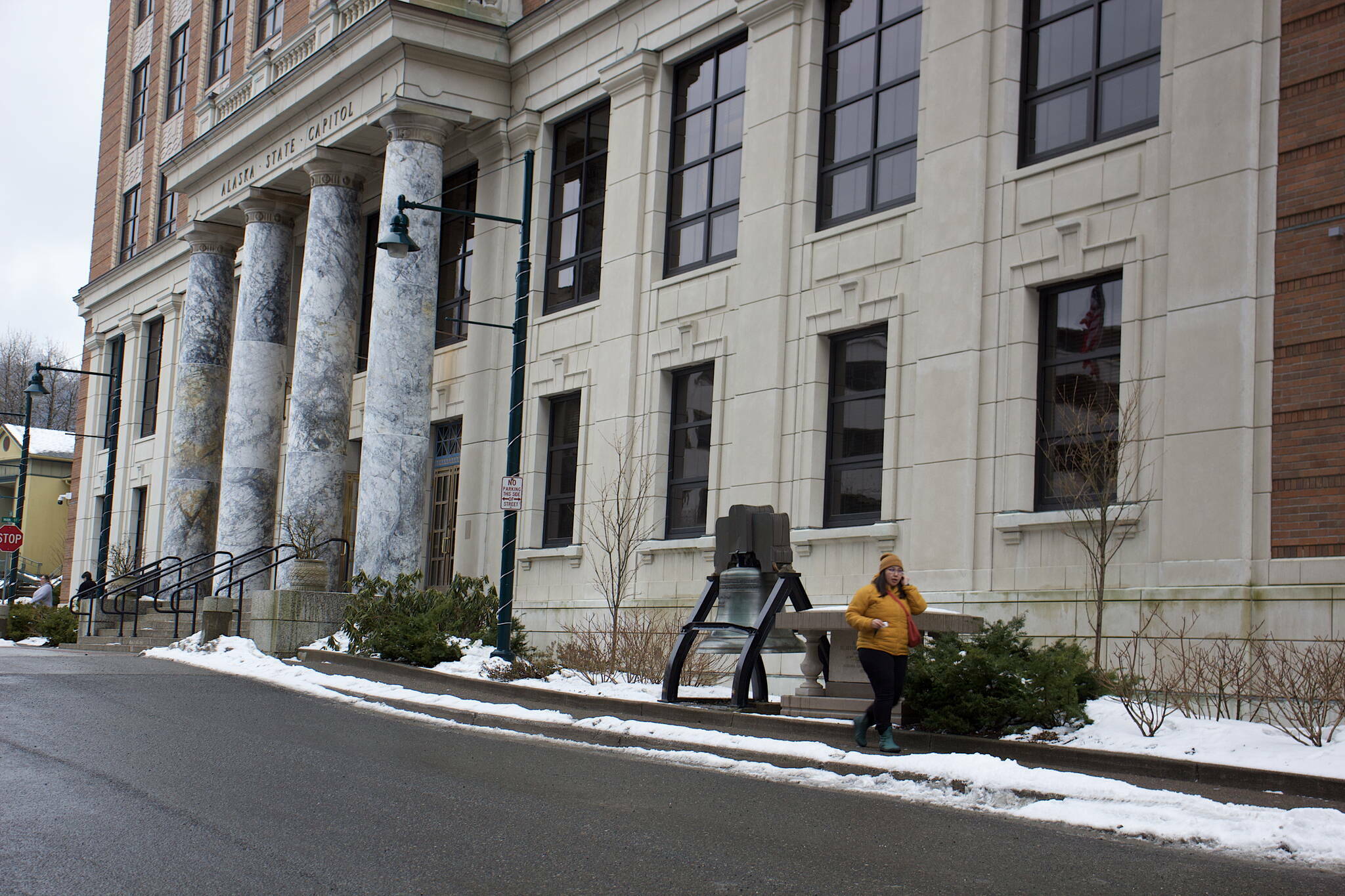An employee leaves the Alaska State Capitol on Wednesday, March 15, 2023. The building was among numerous state capitals targeted by bomb threats that federal law enforcement officials are calling a hoax. (Mark Sabbatini / Juneau Empire file photo)