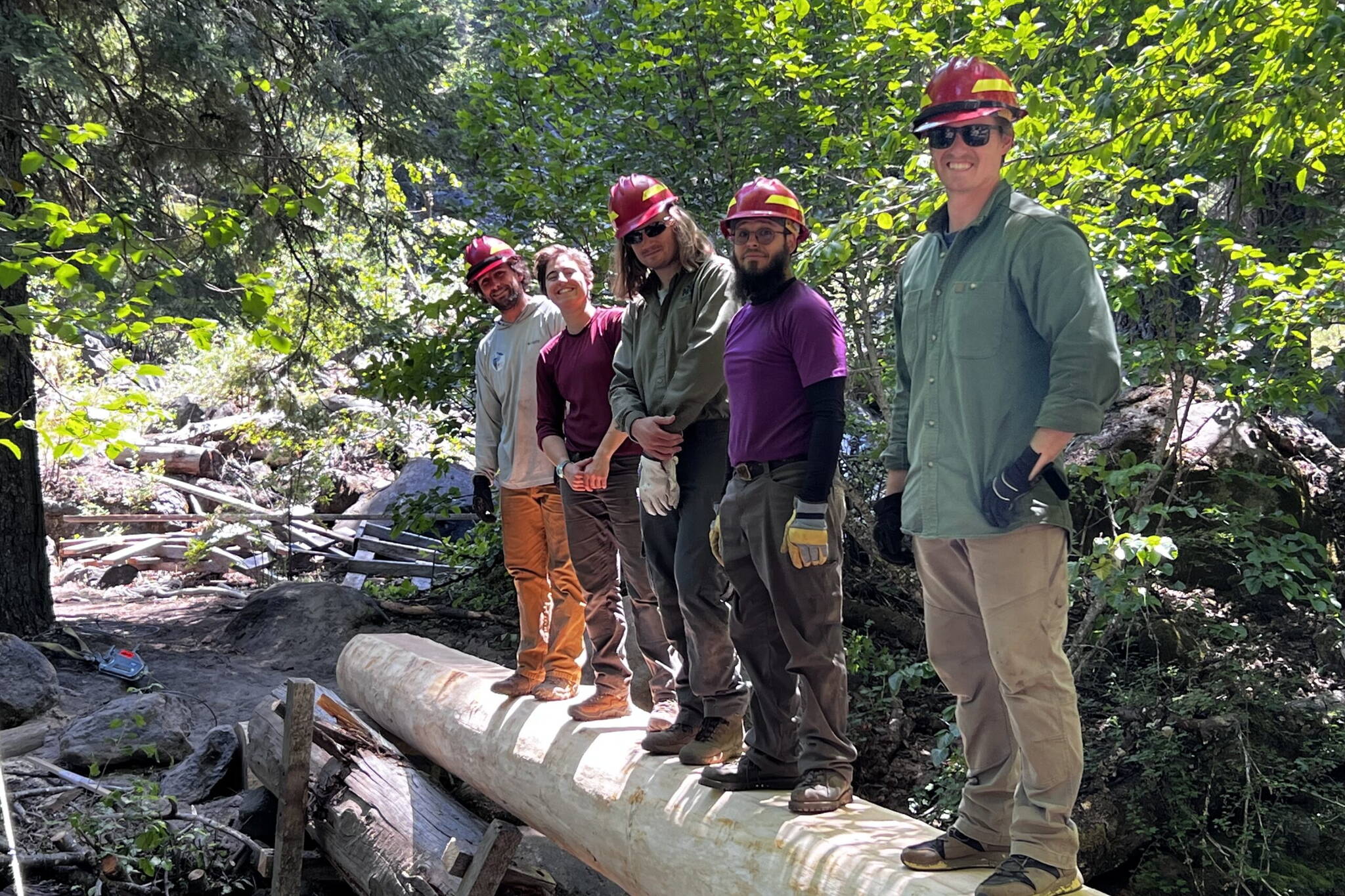 Participants in the 2023 VetsWork AmeriCorps interns program stand on a bridge they built in 2023. (Photo courtesy of the Mt. Adams Institute)