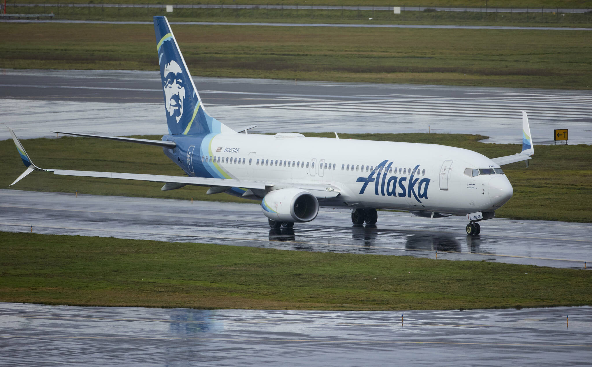 Alaska Airlines flight 1276, a Boeing 737-900, taxis before takeoff from Portland International Airport in Portland, Ore., on Saturday. The FAA has ordered the temporary grounding of Boeing 737 MAX 9 aircraft after part of the fuselage blew out during a flight. (AP Photo/Craig Mitchelldyer)