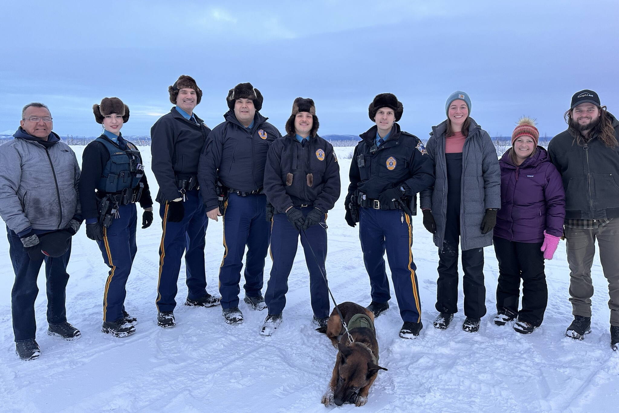 Fairbanks-based Alaska State Troopers visiting the Interior village of Allakaket in December 2023 pose for a photo while wearing fur hats. Such hats are provided by the state to help troopers work in cold conditions. The Department of Public Safety is now seeking to replenish its supply of fur hats to be used by troopers. (Photo provided by the Alaska State Troopers)