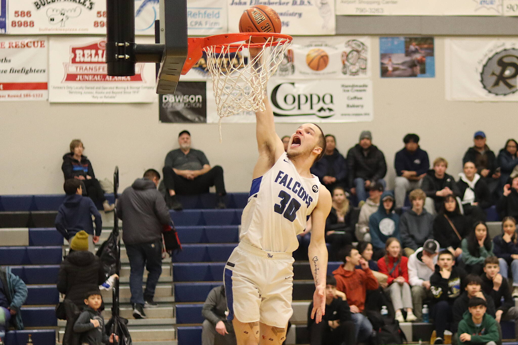 Thomas Baxter scores on a breakaway dunk for Thunder Mountain High School during Saturday’s game against Sitka High School at TMHS. (Mark Sabbatini / Juneau Empire)