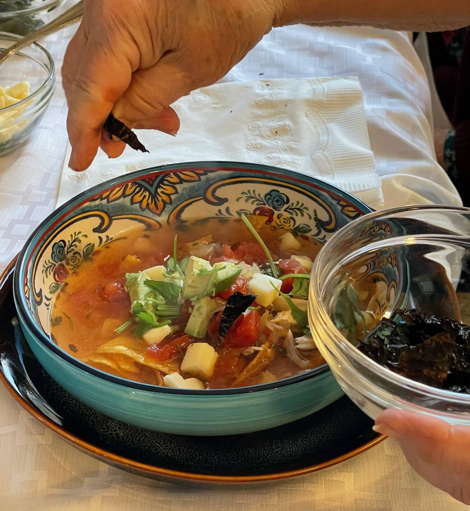 Garnishing a bowl of tortilla soup. (Photo by Laurie Craig)