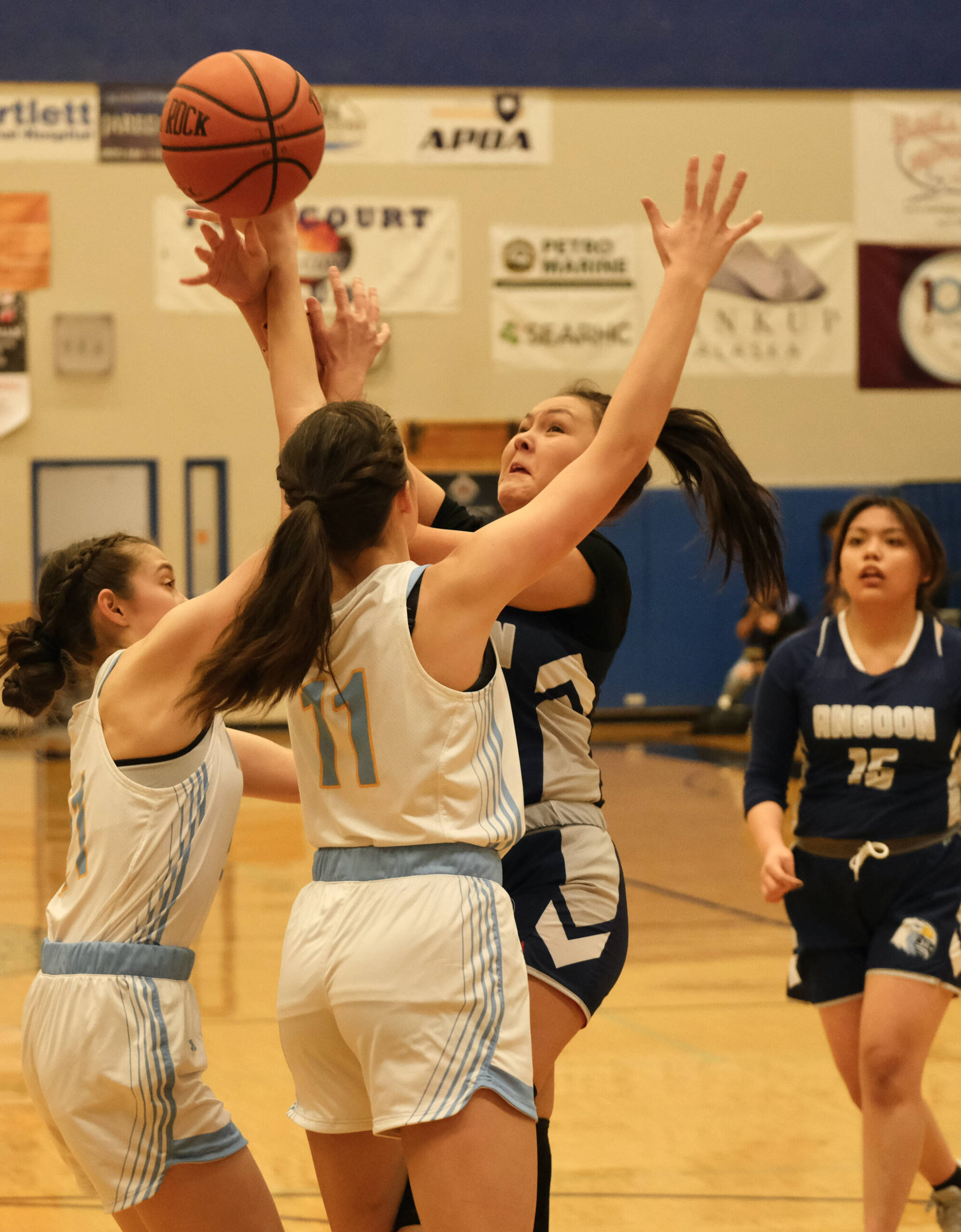 Angoon’s Faith Ramey is fouled on a shot by Dillingham’s Kalin Clouse (11) during the Elizabeth Peratrovich Women’s High School Basketball Invitational Tournament on Thursday at Thunder Mountain High School. The tournament runs through Saturday. (Klas Stolpe / For the Juneau Empire)