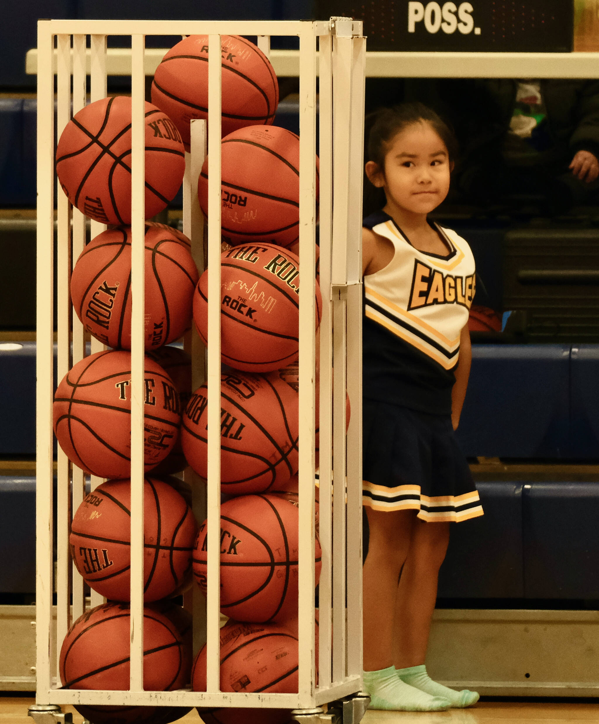 Angoon fan, and cheerleader, Blake Herrera Johnson, 5, awaits the start of the Eagles game against the Dillingham Wolverines during the Elizabeth Peratrovich Women’s High School Basketball Invitational Tournament on Thursday at Thunder Mountain High School. The tournament runs through Saturday. (Klas Stolpe / For the Juneau Empire)