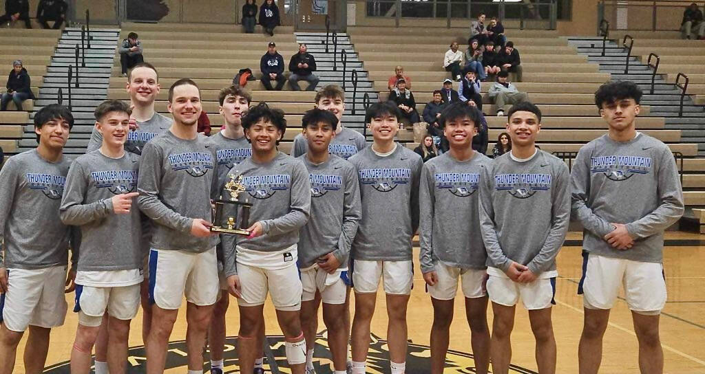 The Thunder Mountain High School Falcons boys basketball team are shown with their championship trophy after winning the Wolverine Classic Tournament at South Anchorage High School on Saturday. (Photo courtesy TMHS)